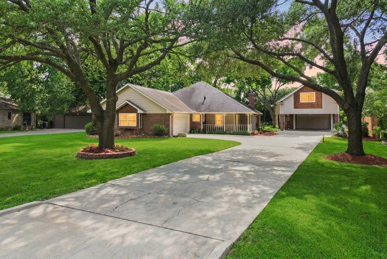 Wide open green space, shady oak trees, & a welcoming front porch create the perfect backdrop for slow mornings & relaxing evenings outdoors.