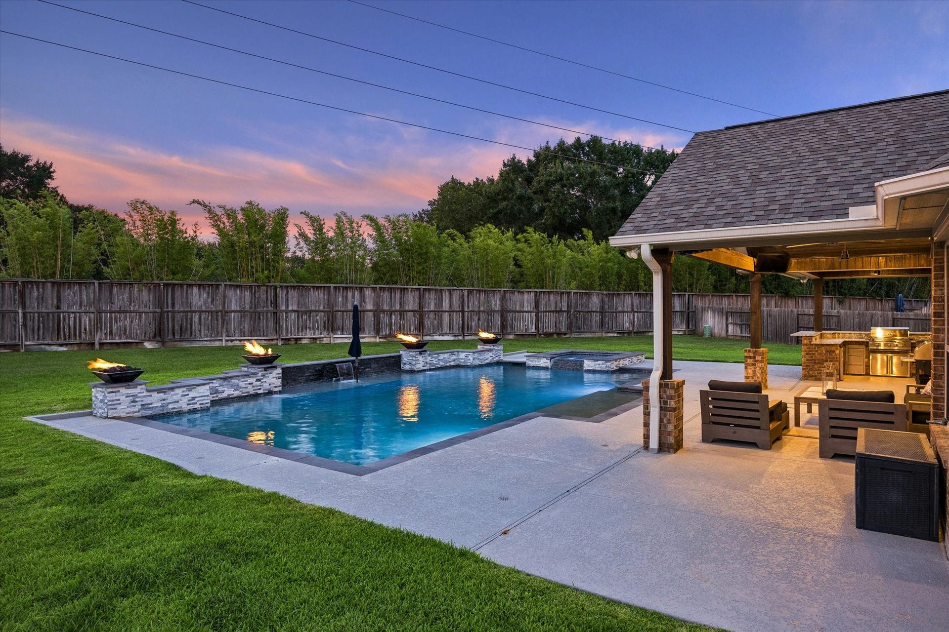 20338 Sienna Bluff Drive, Cypress, TX 77433 As the sun sets, the glowing pool and illuminated patio transform this space into an unforgettable destination for evening entertaining.