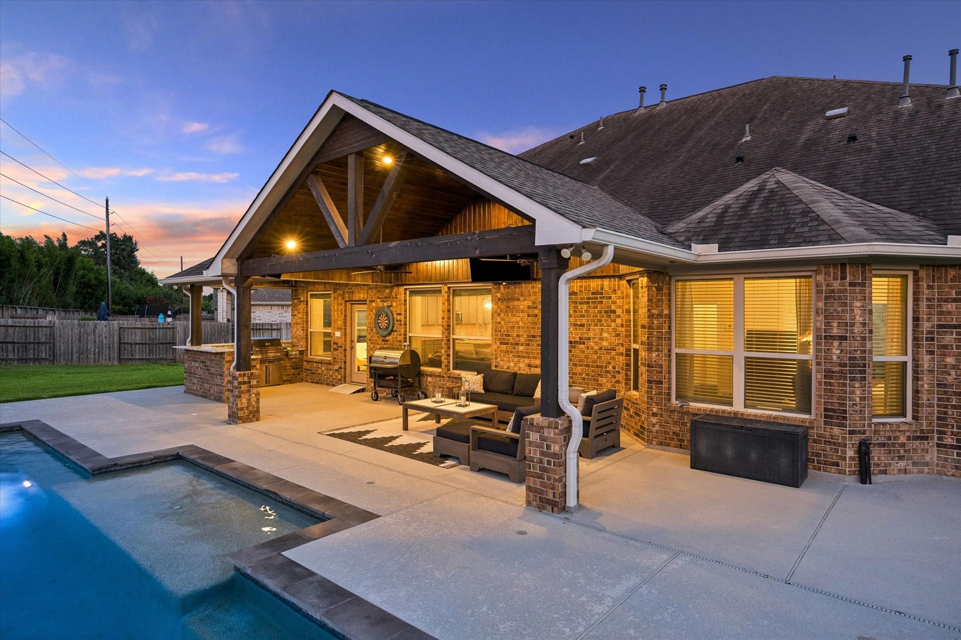 20338 Sienna Bluff Drive, Cypress, TX 77433 Extend your living space outdoors with this beautifully designed covered patio overlooking the sparkling pool. this exceptional backyard is designed for effortless indoor-outdoor living and memorable evenings under the Texas sky.