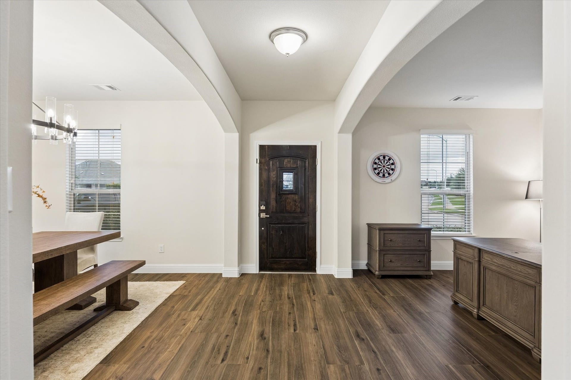 20338 Sienna Bluff Drive, Cypress, TX 77433 Large white arched openings divide the dining area from the foyer/living space, creating a dramatic but welcoming feel.