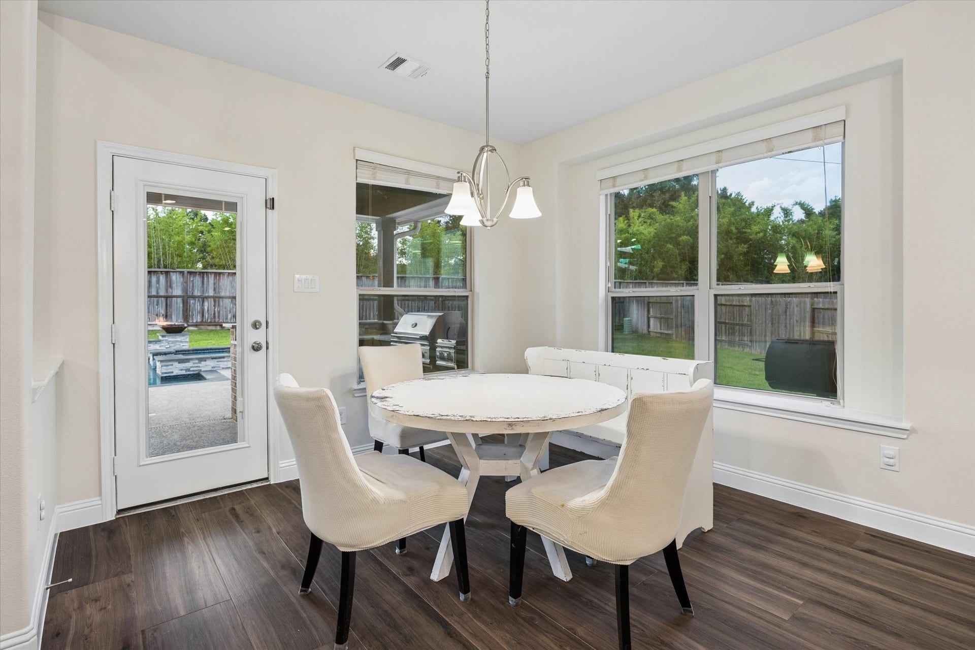 20338 Sienna Bluff Drive, Cypress, TX 77433 Bright and inviting breakfast nook with abundant natural light from large windows. A full glass-paneled door provides easy access to the backyard!