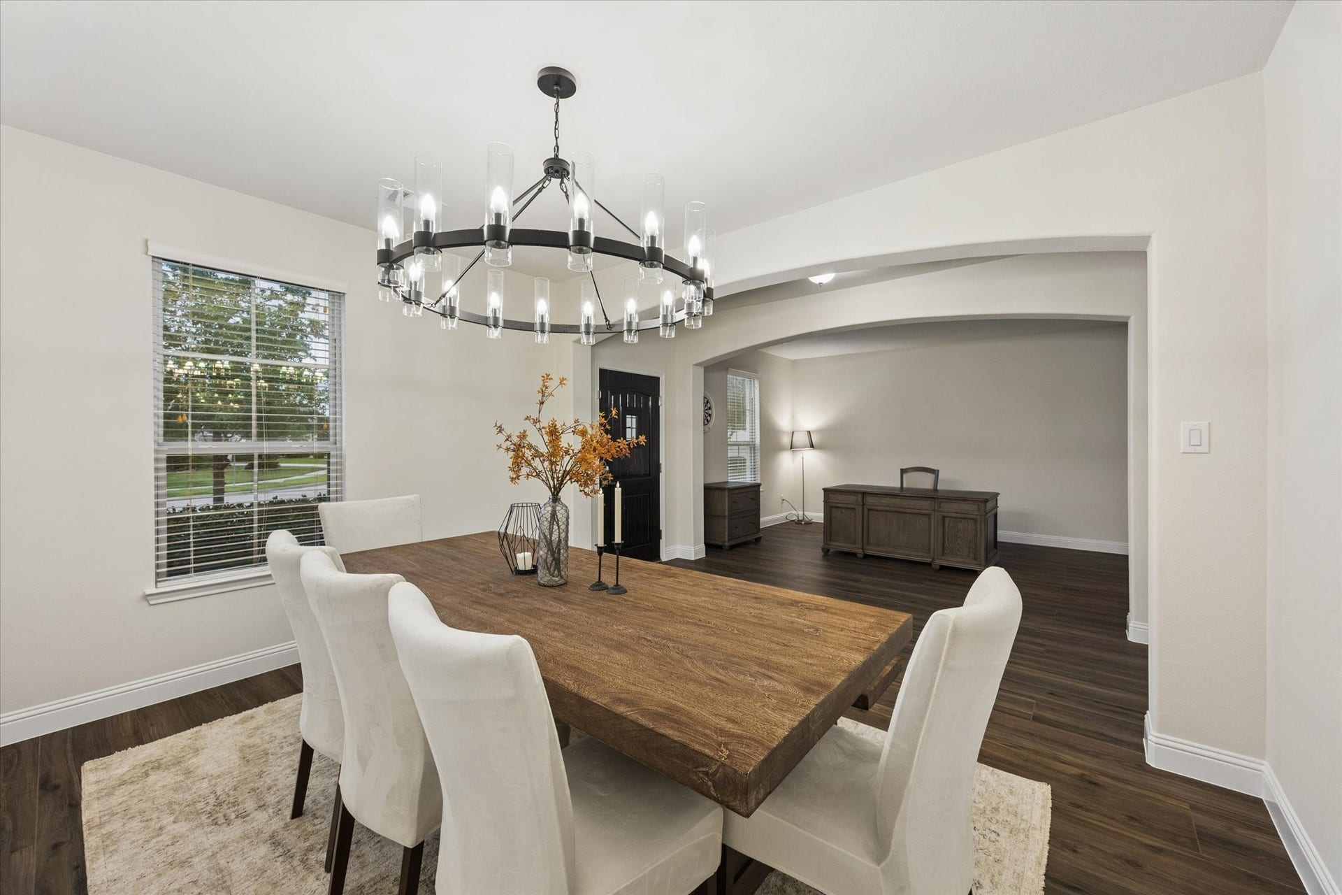 20338 Sienna Bluff Drive, Cypress, TX 77433 Arched architectural details, neutral finishes, and abundant natural light create a warm, sophisticated setting perfect for both everyday dining and entertaining. Stylish wagon wheel chandelier definitely makes a statement!