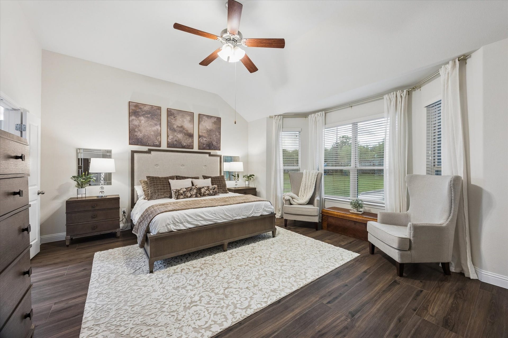 20338 Sienna Bluff Drive, Cypress, TX 77433 Serene primary bedroom featuring a vaulted ceiling, a wall of large windows that fills the room with light and offers peaceful backyard views!