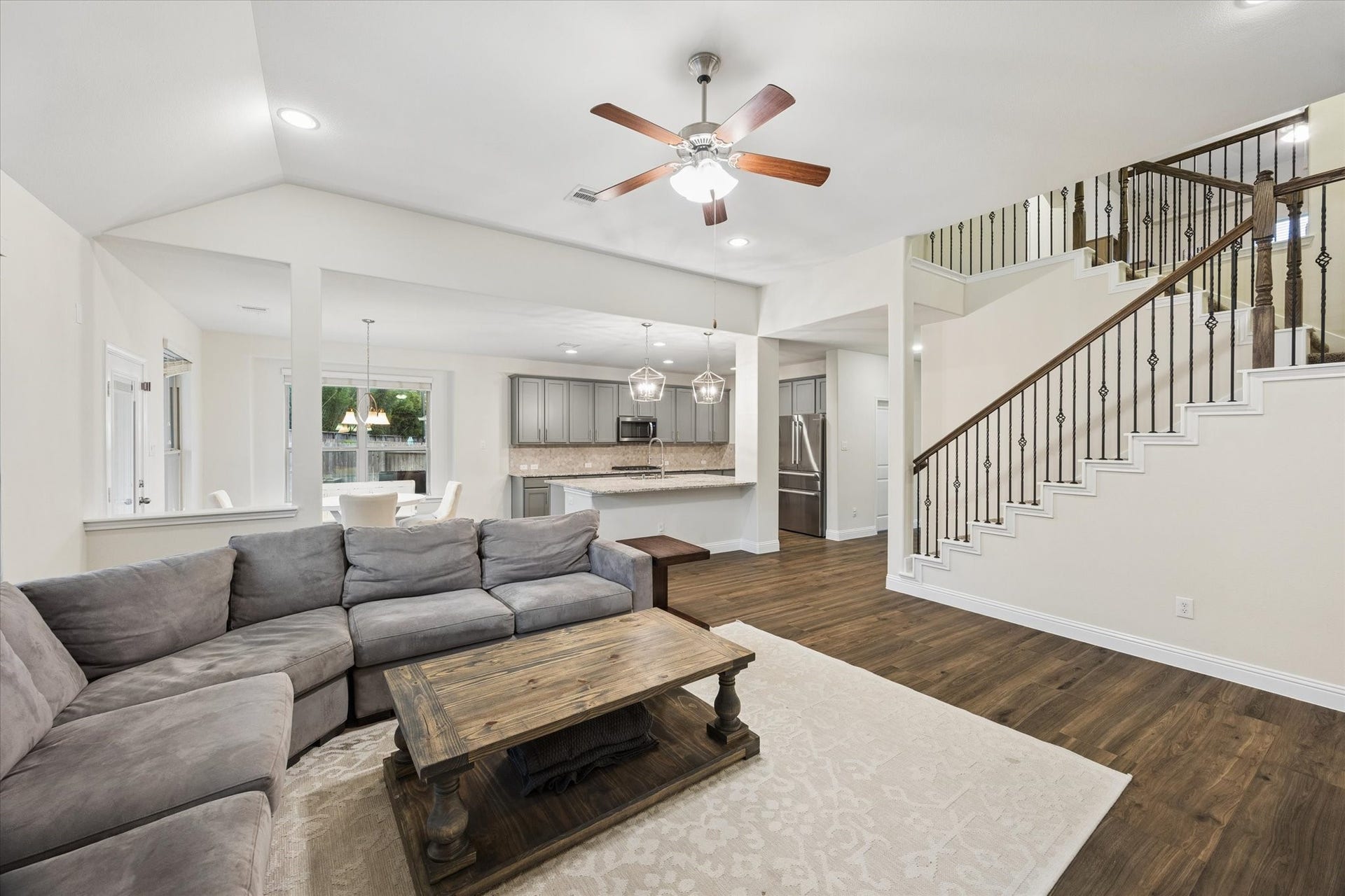 20338 Sienna Bluff Drive, Cypress, TX 77433 This open floorplan connects the family room, breakfast area, and kitchen - wonderful flow. A beautifully detailed staircase with wrought-iron railing adds architectural character and a sophisticated focal point to the space.