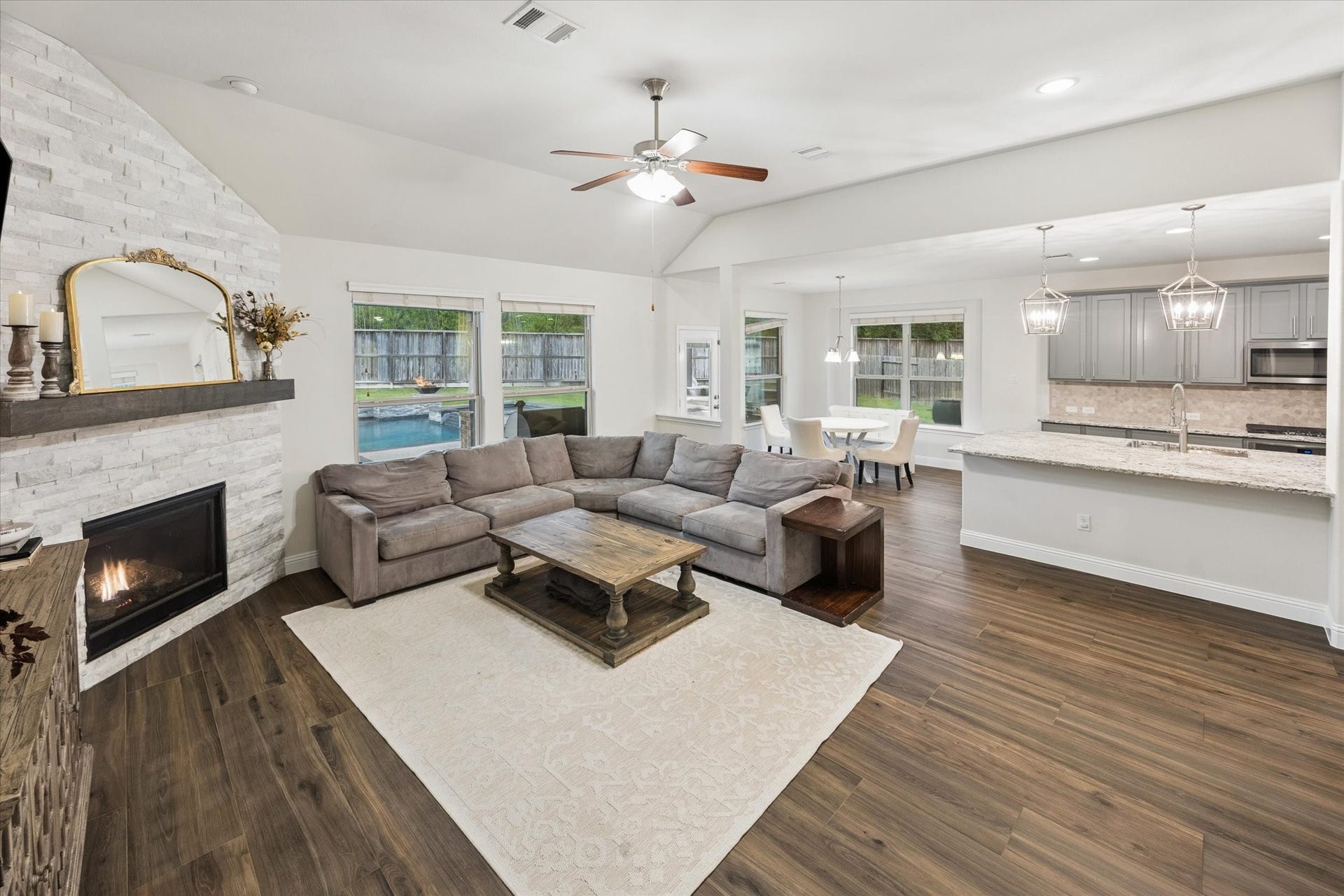 20338 Sienna Bluff Drive, Cypress, TX 77433 Large windows overlook the backyard and pool. All main area flooring is with luxurious wood-like tile floors.