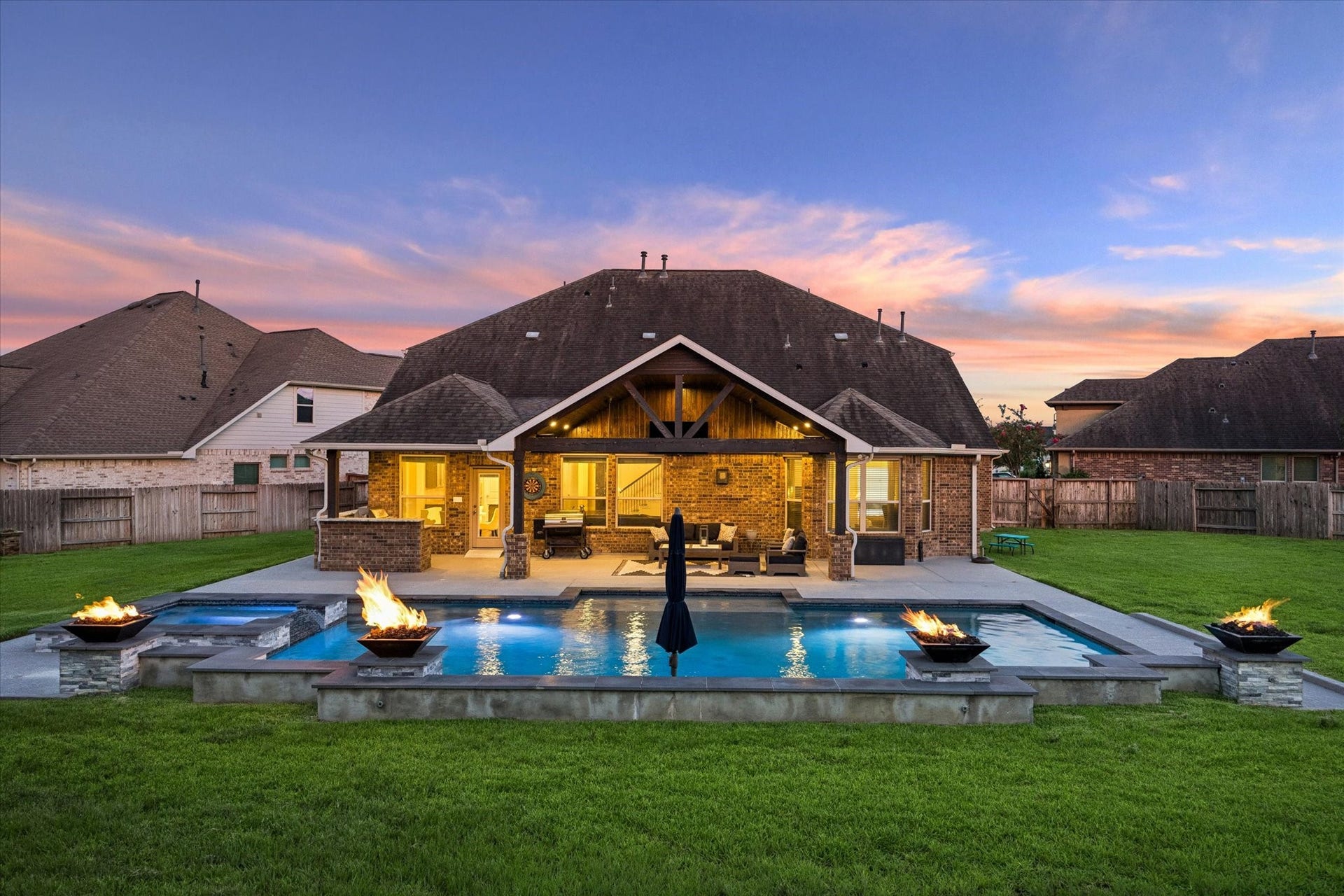 20338 Sienna Bluff Drive, Cypress, TX 77433 An extraordinary outdoor retreat awaits in this beautifully designed backyard, where resort-style amenities create an effortless setting for entertaining and relaxation. The expansive pool takes center stage, framed by multiple raised fire features that add warmth & ambiance!