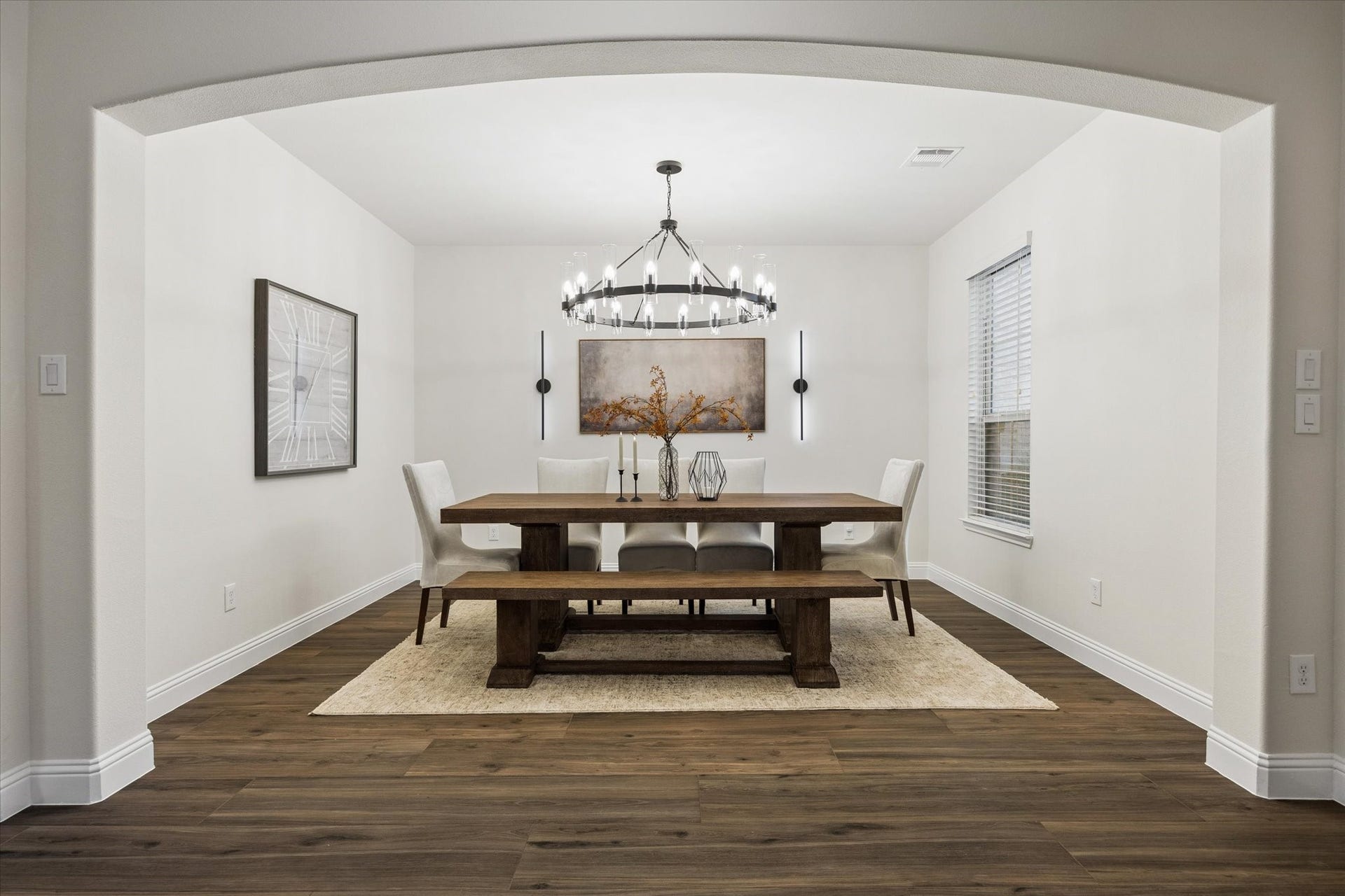 20338 Sienna Bluff Drive, Cypress, TX 77433 Welcoming dining area featuring a classic arched entry, warm wood flooring, and large enough to fit a substantial size wood dining table with bench seating. Neutral recessed details. This is an ideal space for everyday meals or entertaining.
