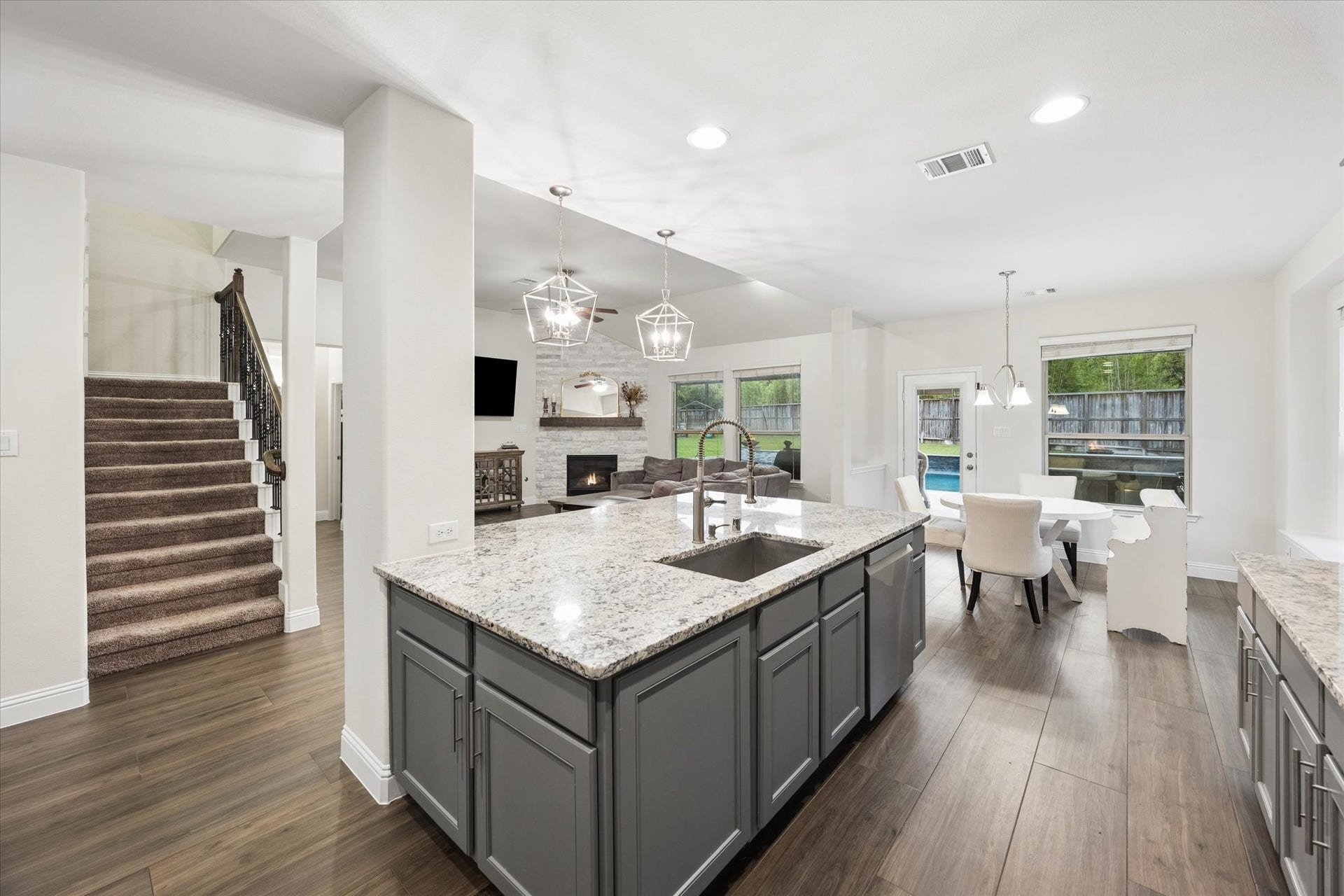 20338 Sienna Bluff Drive, Cypress, TX 77433 Elegant pendant lighting and recessed fixtures add a polished touch, while the open-concept design flows seamlessly into the main living areas and showcases the home's staircase and generous layout.