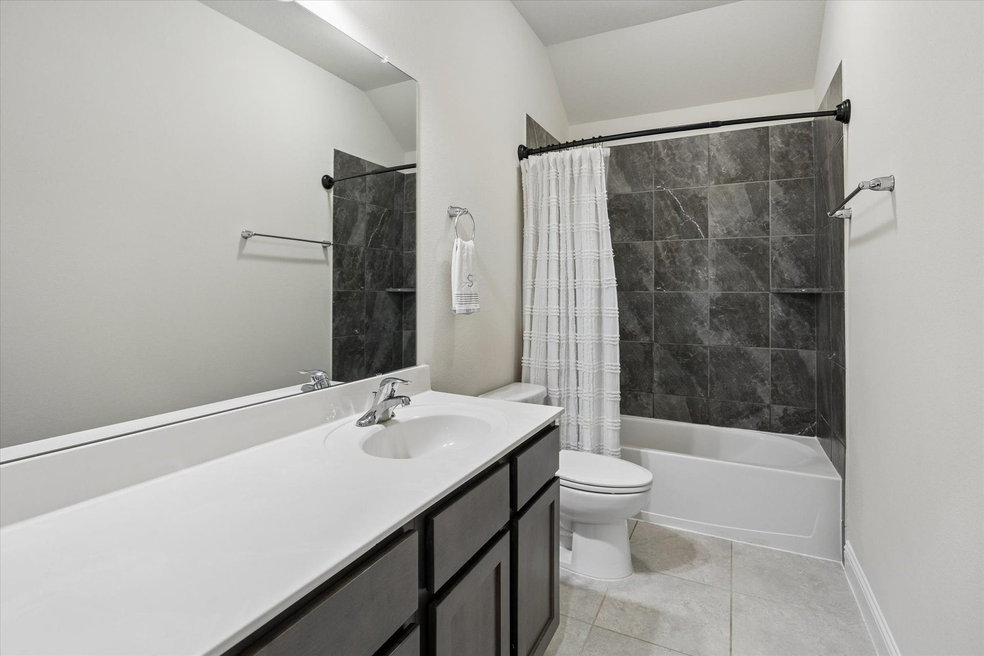 20338 Sienna Bluff Drive, Cypress, TX 77433 Secondary bathroom upstairs conveniently close to the game room with contemporary finishes. A crisp white vanity with ample counter space.