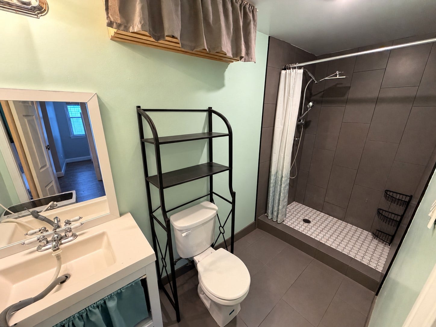 Full bathroom featuring a single-sink vanity and walk-in shower.