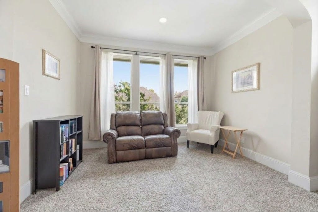 5414 Lake Hill Farm Way, Fulshear, TX 77441 Dedicated sitting alcove off the primary bedroom featuring carpet flooring, recessed lighting, crown molding, and a bank of three large windows providing ample natural lighting.