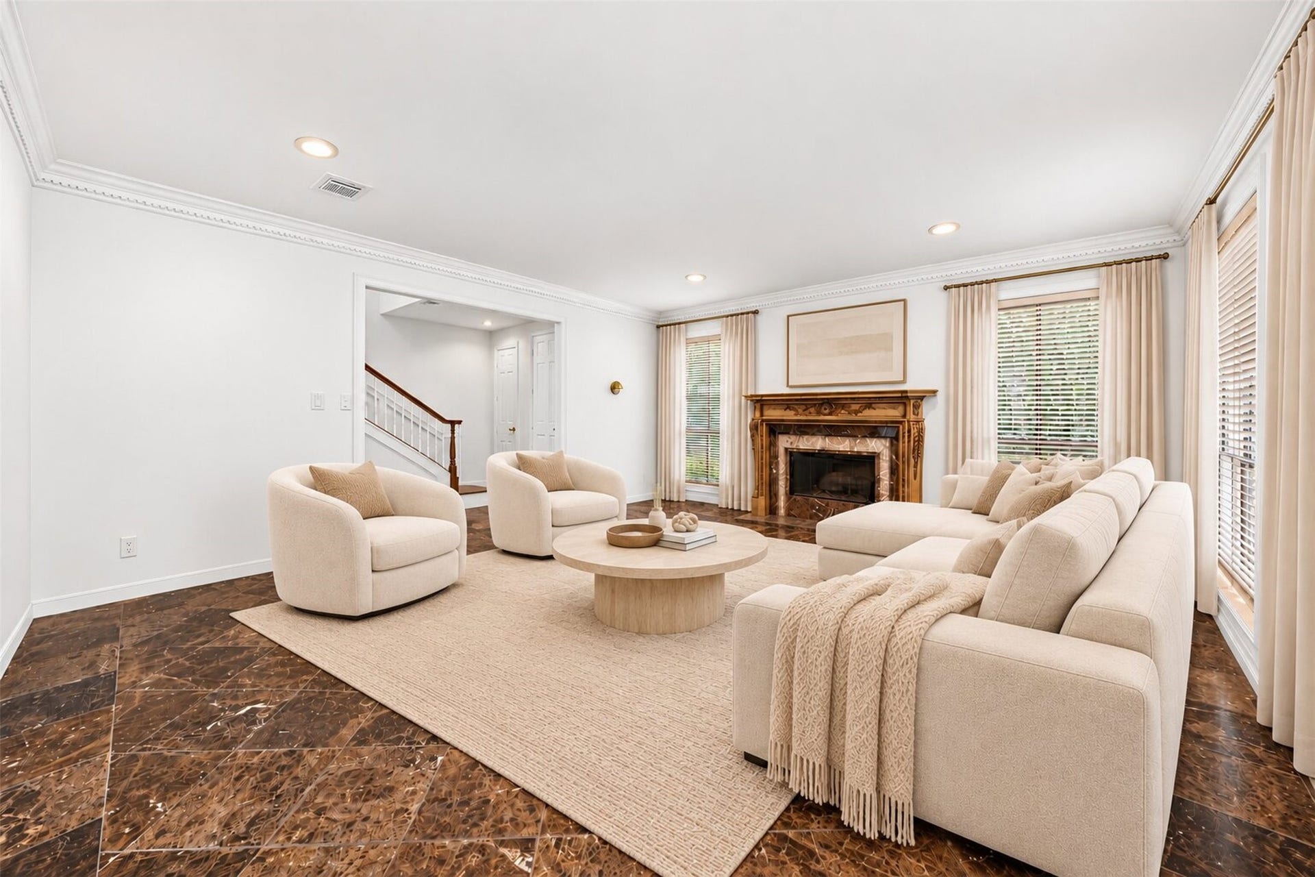 Virtually staged living room with a fireplace, tall windows and crown molding.