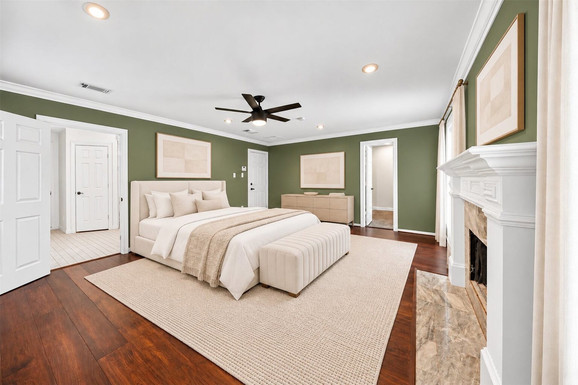 Virtually staged primary bedroom with green walls, a fireplace and a ceiling fan.