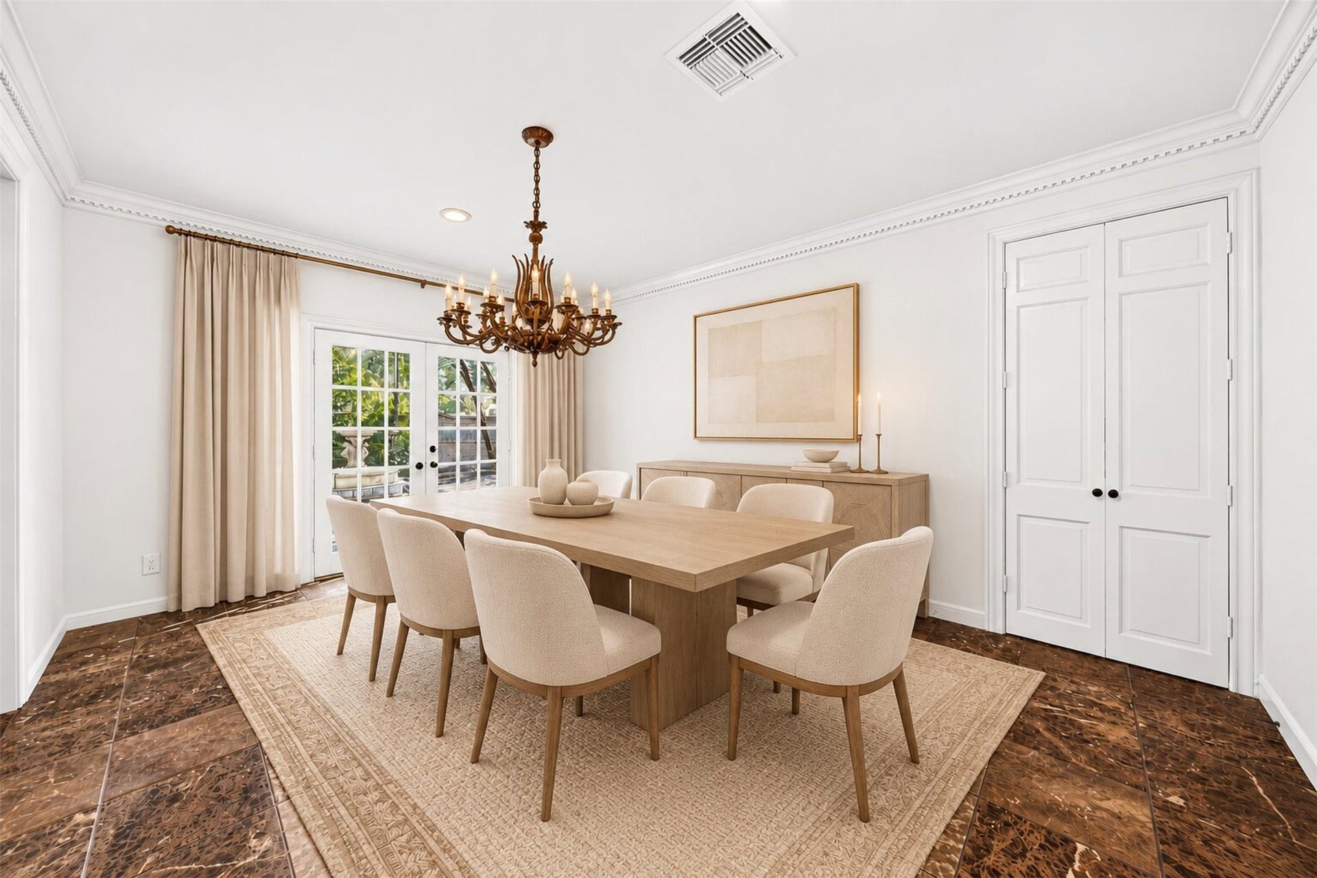 Virtually staged dining room with a chandelier and French doors to the courtyard.