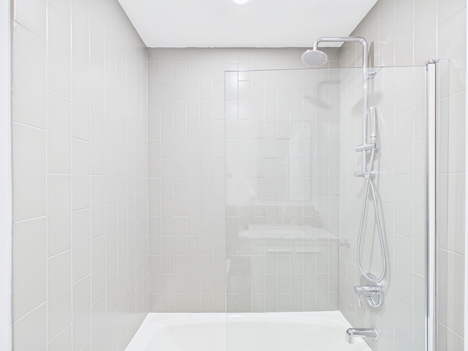 Elegant Tub/Shower Combo with Vertical Subway Tiling