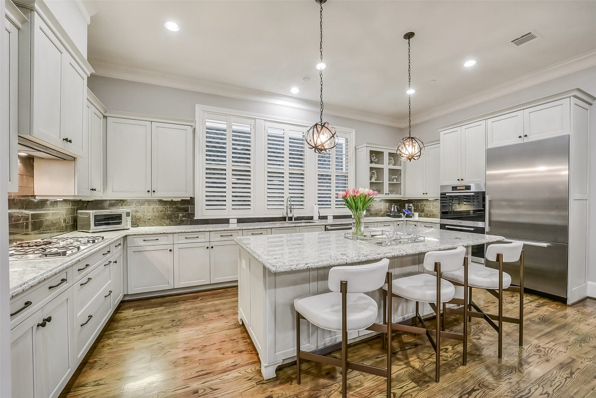 11 Southside Circle, Southside Place, TX 77025 Alternate view of the gourmet kitchen highlighting the expansive layout. This culinary space is outfitted with premium Miele appliances including a speed oven.