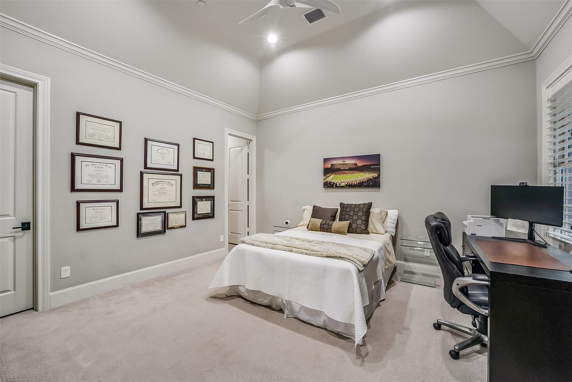 11 Southside Circle, Southside Place, TX 77025 Very spacious secondary bedroom with soaring vaulted ceilings. A ceiling fan and large window with shutters provide comfort and natural light, with room for a home office setup.