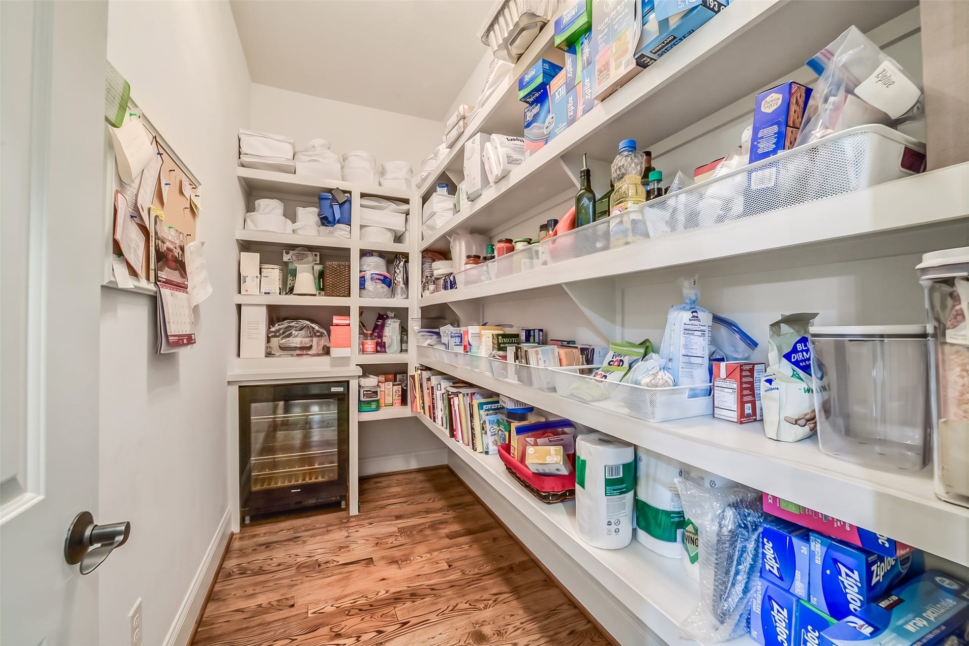11 Southside Circle, Southside Place, TX 77025 Walk-in pantry with custom built-in shelving and a built-in wine refrigerator.