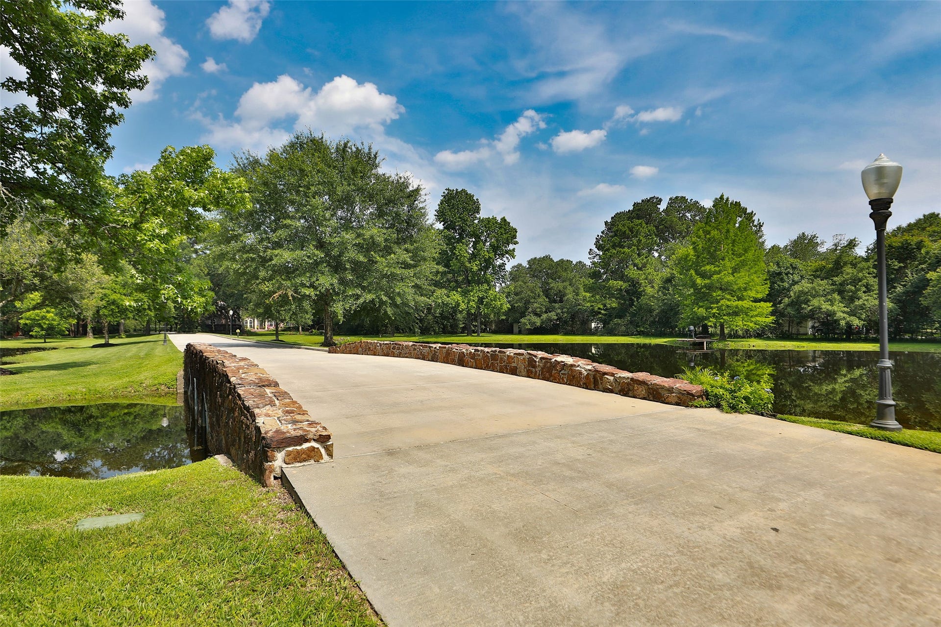 Imagine coming home every day to this breathtaking view! As you cross the charming stone bridge overlooking your private stocked pond, you're welcomed by the beauty and tranquility of your own estate. This isn't just a drivewayit's an unforgettable entrance to a place you'll love calling home!