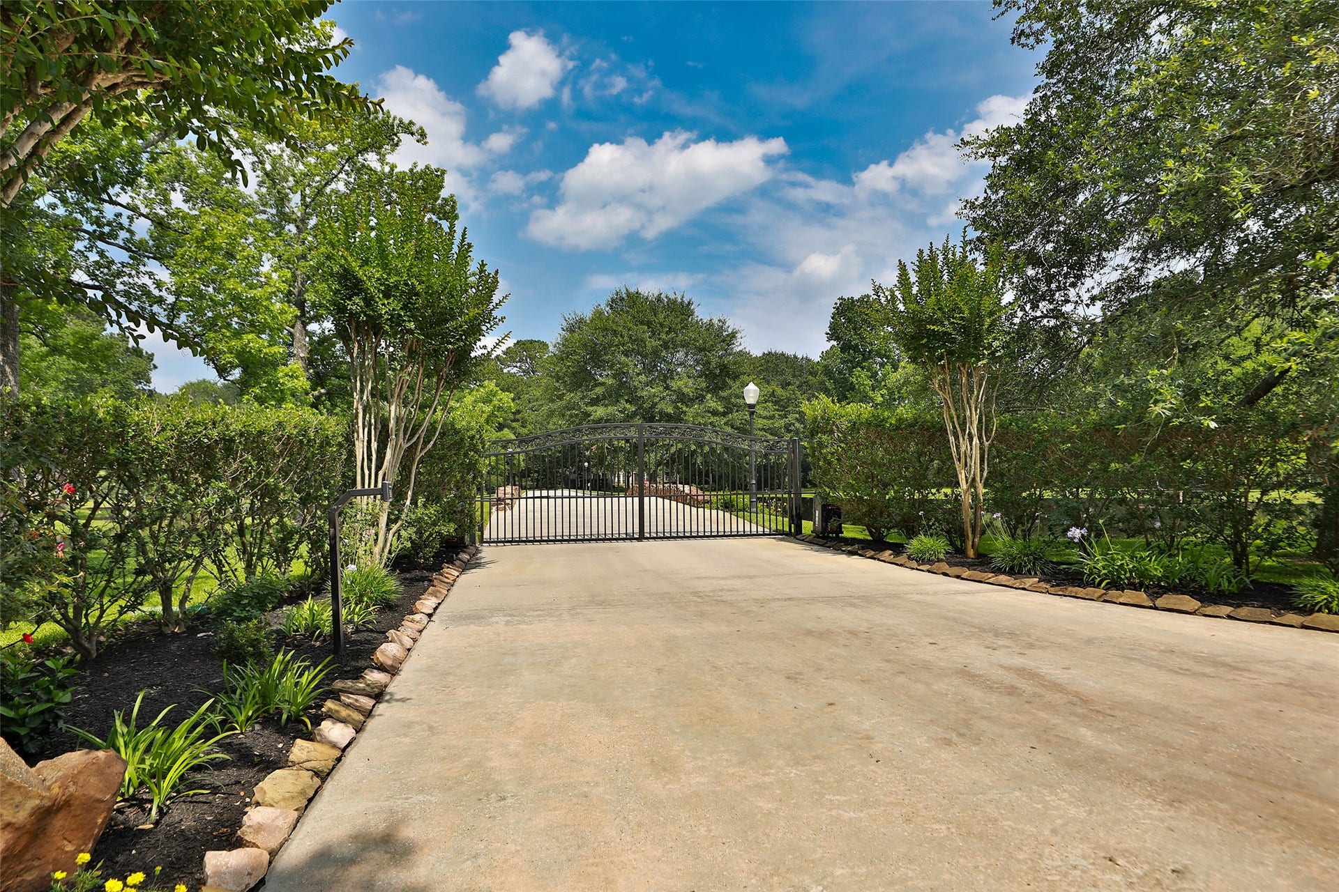 Beautifully landscaped gated entrance with Lift-Master gate motors, keypad and remotes.