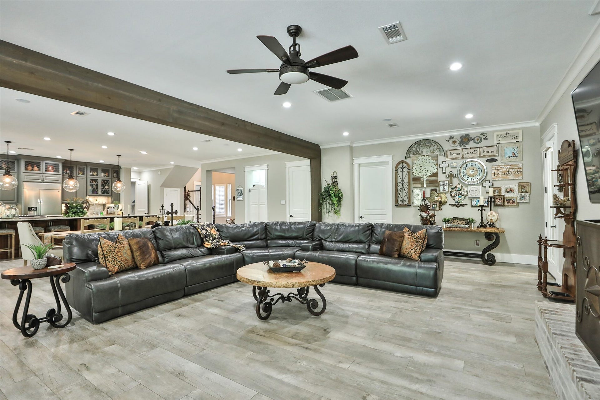 Living room is 27x18 with a beautiful gas fireplace, large picture windows crown molding, ceiling fan and recessed lighting.