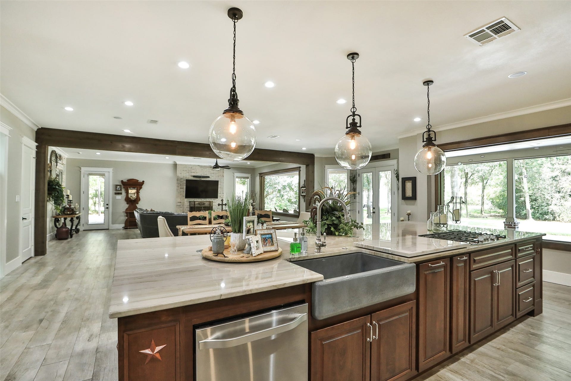 At the heart of this extraordinary estate is a magazine-worthy custom kitchen, beautifully remodeled with handcrafted floor-to-ceiling cabinetry, an impressive 15' x 7' solid cherry island, premium built-in LG Studio appliances, Taj Mahal quartzite countertops, designer lighting, and abundant storage. The open-concept design flows effortlessly into the dining and great room, creating an elegant yet welcoming space for entertaining on any scale. Combined with the home's extensive renovation.