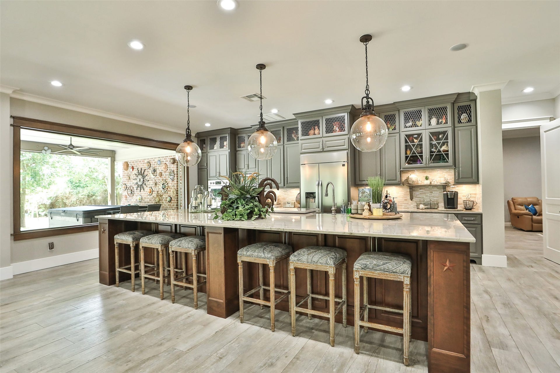 The spacious, open-concept design offers abundant storage, generous seating, and the perfect gathering place for family and friends. A stunning combination of luxury, craftsmanship, and functionality that makes this kitchen the heart of the home!