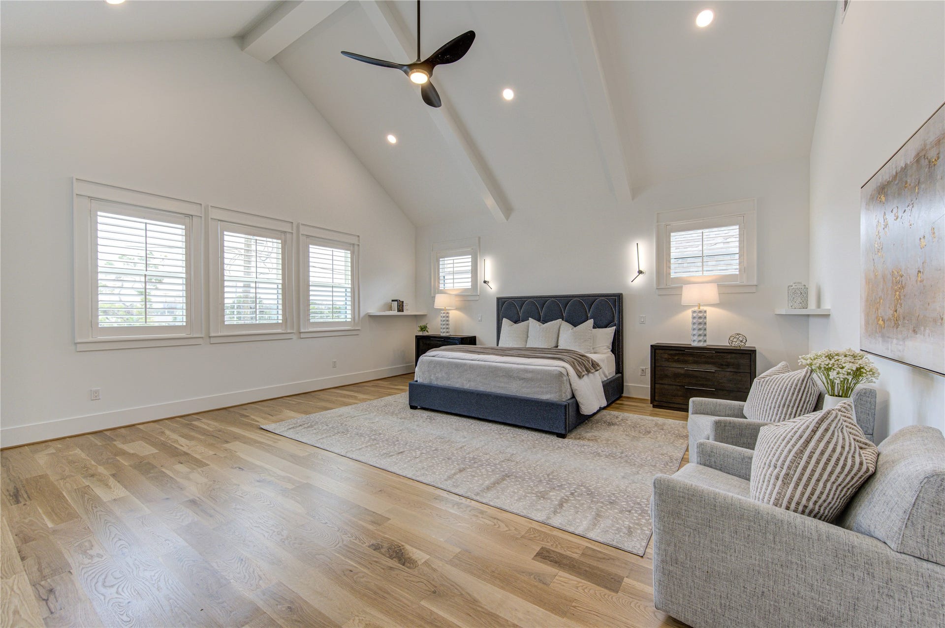 Texas-Size Primary Bedroom with Cathedral Ceiling and tons of natural light through these large windows.