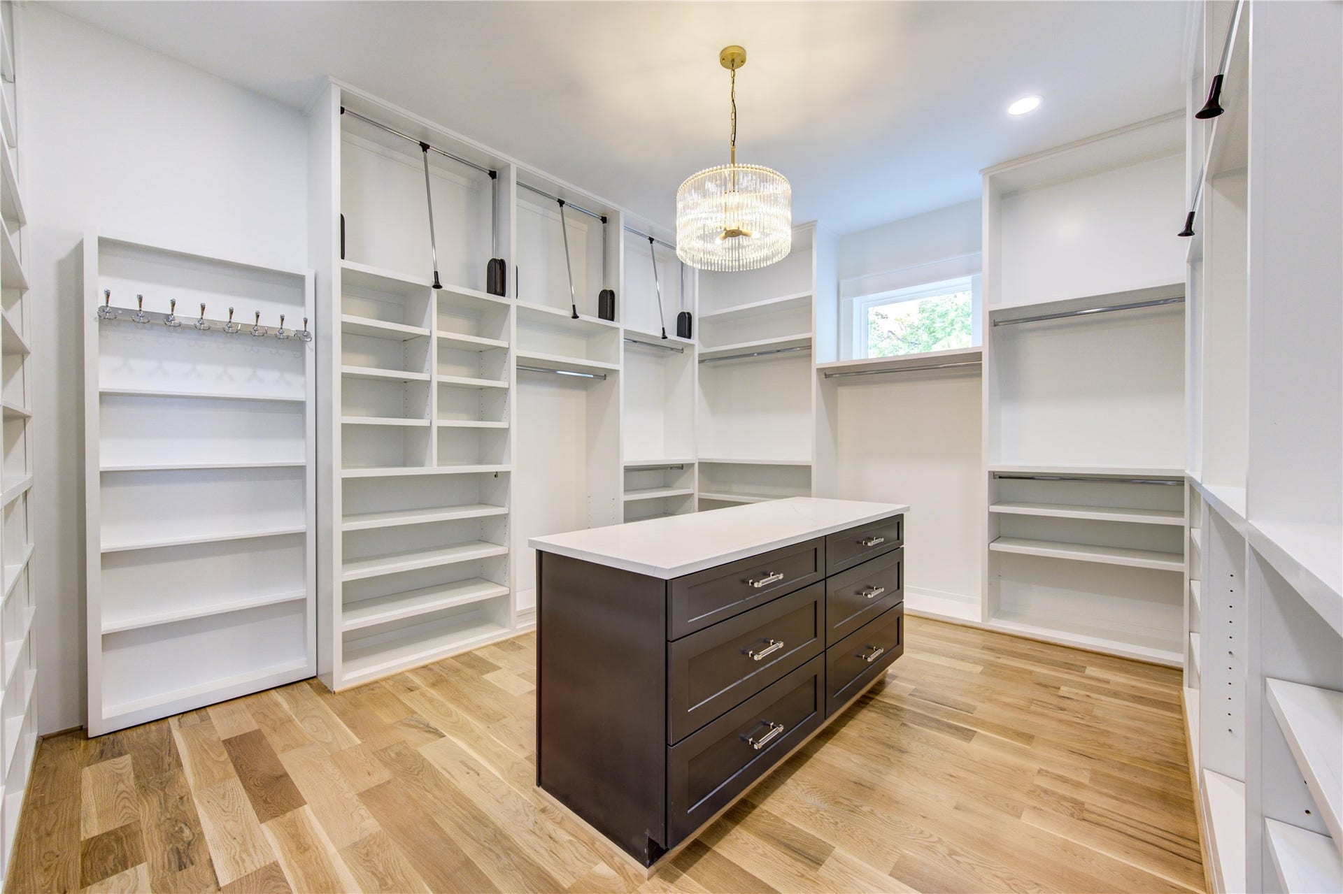 Massive Closet offering many of 3 row hanging spaces w/ Pull-Downs on the top. So much storage for all sorts of needs.