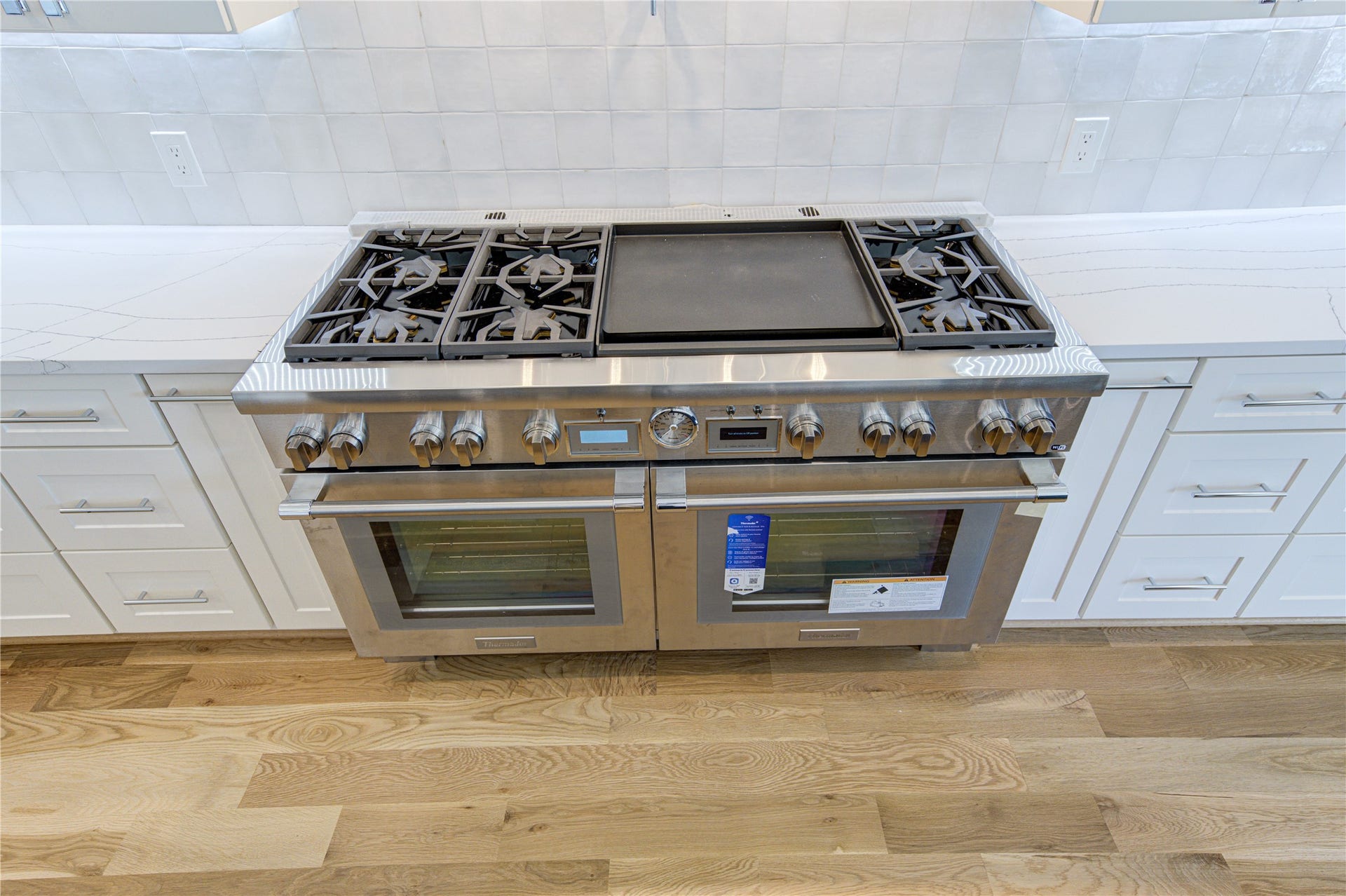 Massive 60" Thermador Pro Grand Range w/ double full-size Oven with matching 60 Vent hood and Pot Filler in between.