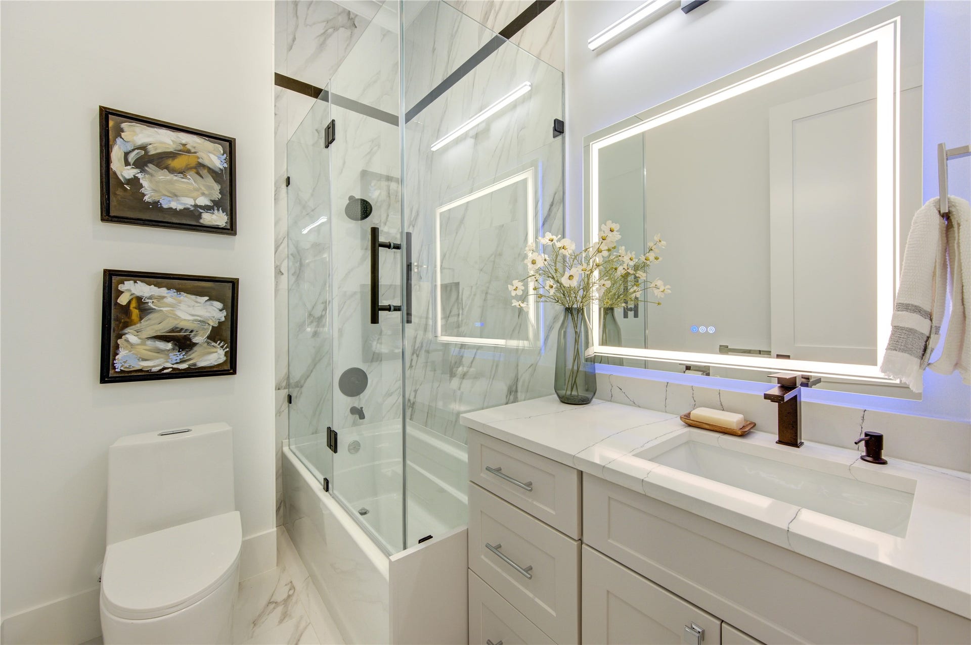 This Full Bath on the Hallway has Colorful LED Mirror, Glass Enclosure tub and Floor-Ceiling Porcelain Tile.