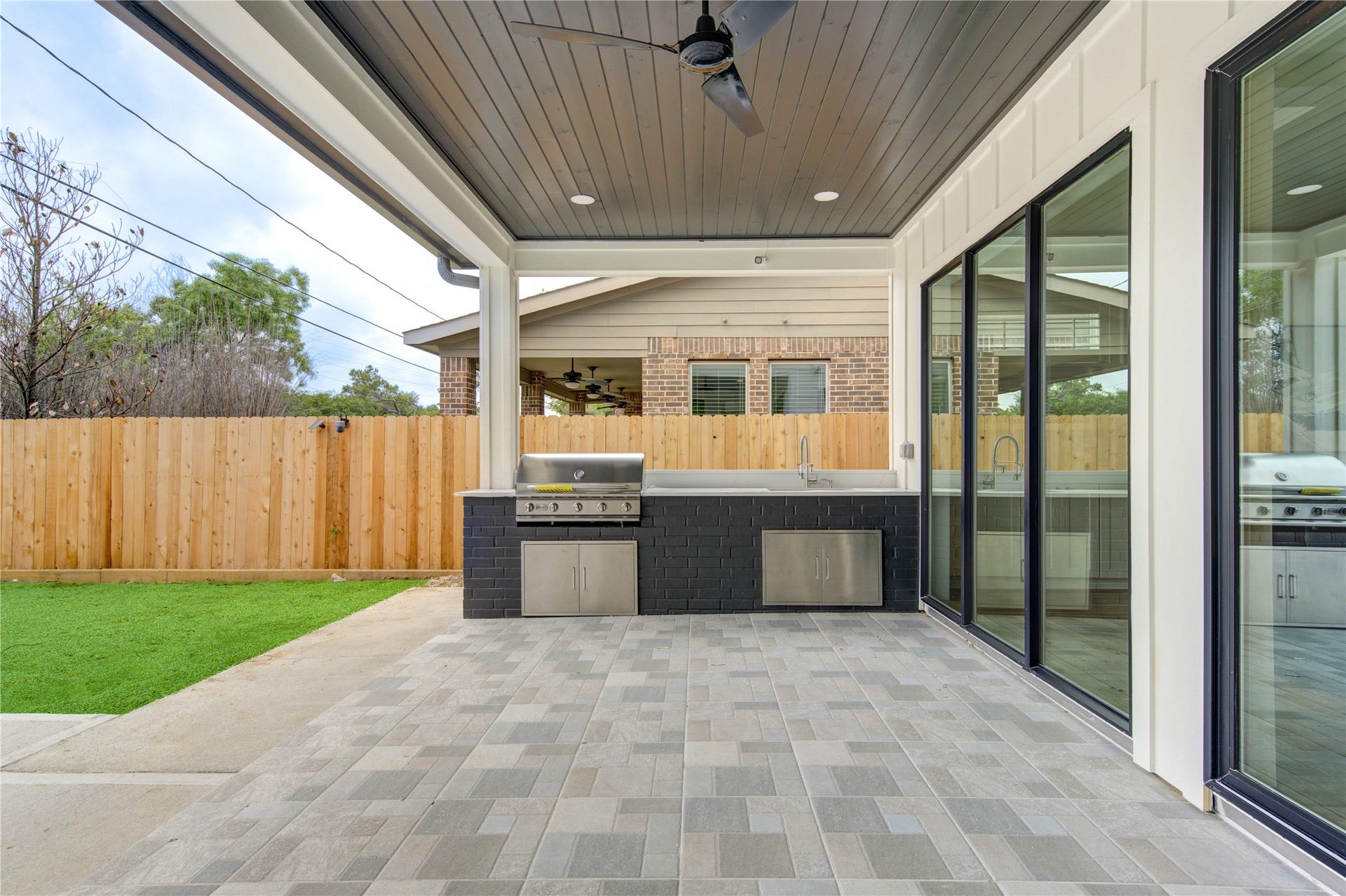 Covered Patio with 5 burner Grill hooked up to Natural Gas line (No propane please) and large sink.