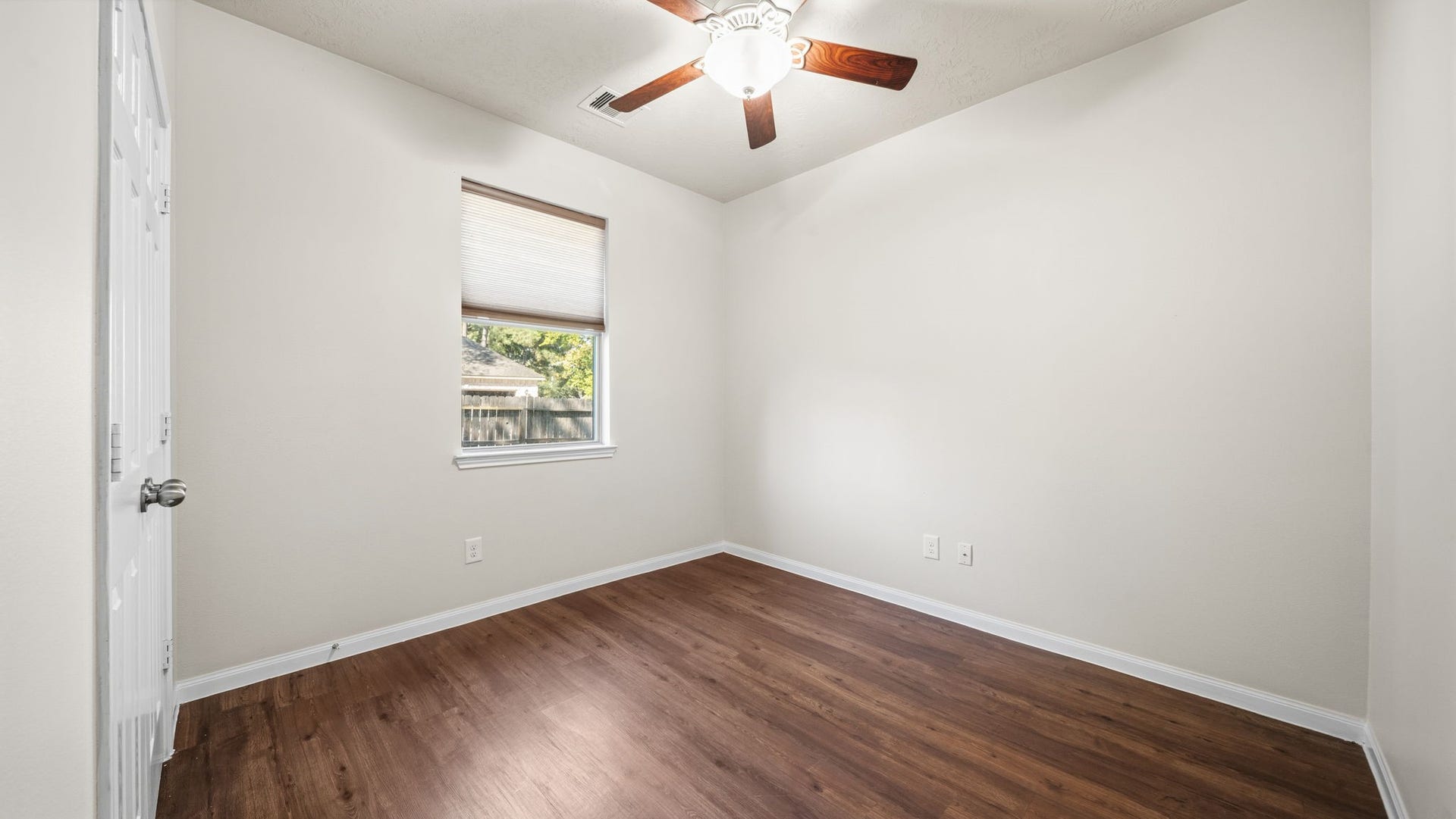 11246 Glenforest Drive, Montgomery, TX 77356 Versatile bedroom with neutral finishes, wood-look flooring, and a ceiling fanready for furnishing and your personal style.