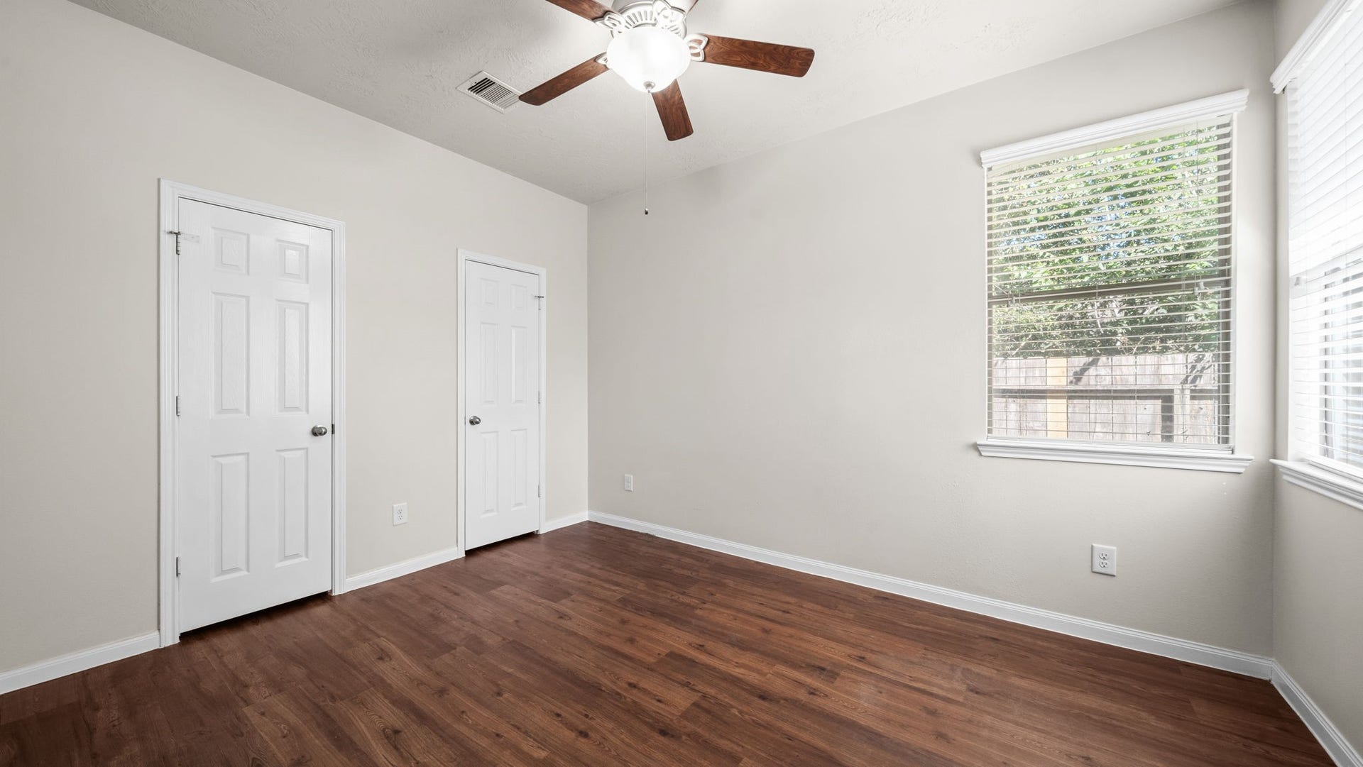 11246 Glenforest Drive, Montgomery, TX 77356 Bright and comfortable secondary bedroom featuring beautiful wood-look flooring, a ceiling fan, and windows that welcome natural light.