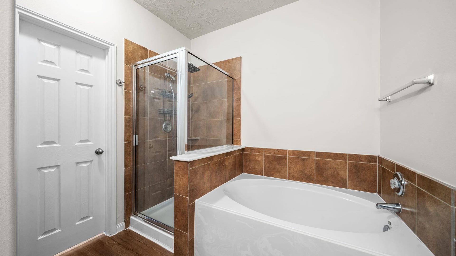 11246 Glenforest Drive, Montgomery, TX 77356 Enjoy a relaxing retreat with a separate soaking tub and glass-enclosed shower, offering both comfort and everyday convenience.