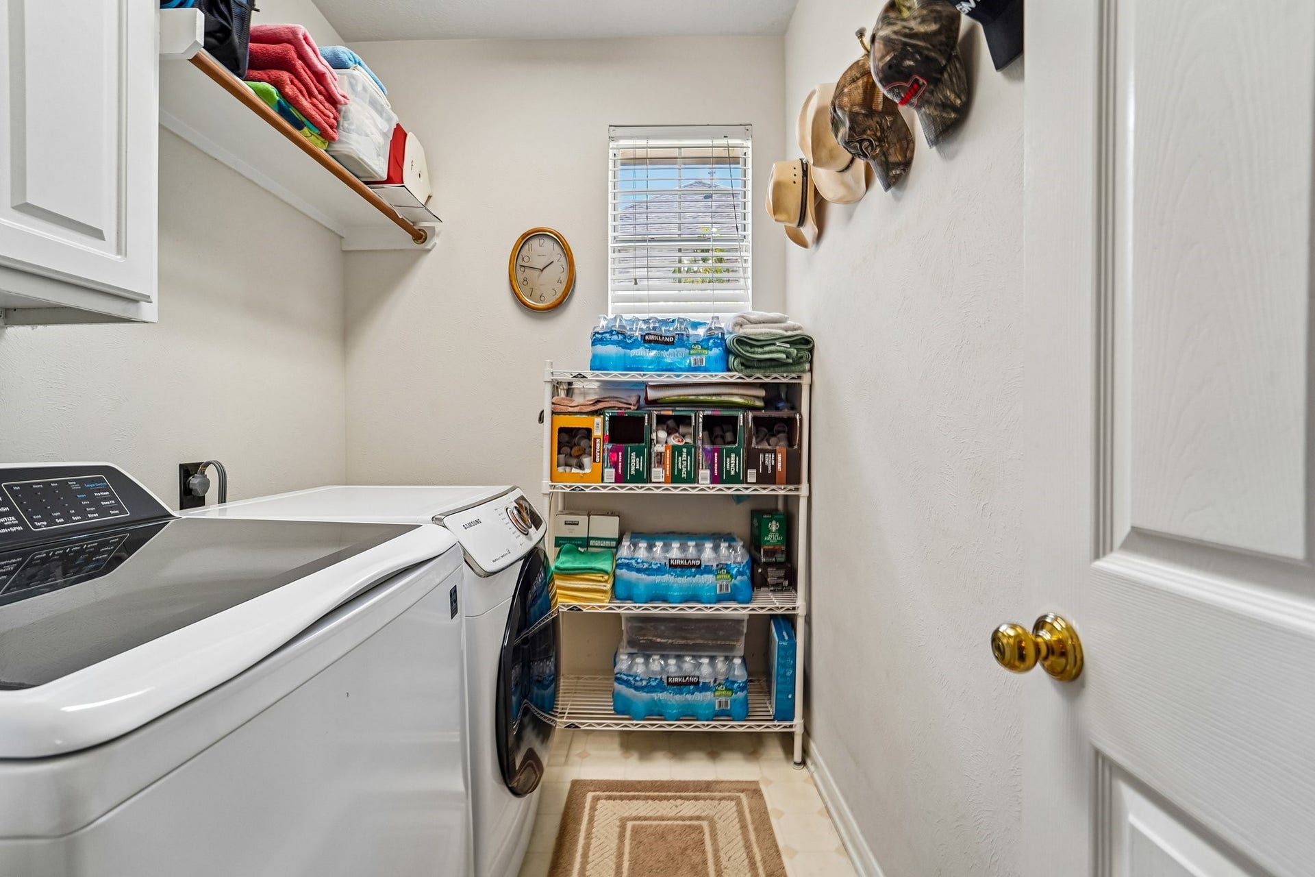 14 Serene Creek Place, The Woodlands, TX 77382 Efficient laundry room with modern appliances, ample storage space, and natural light, providing convenience and organization for daily chores.