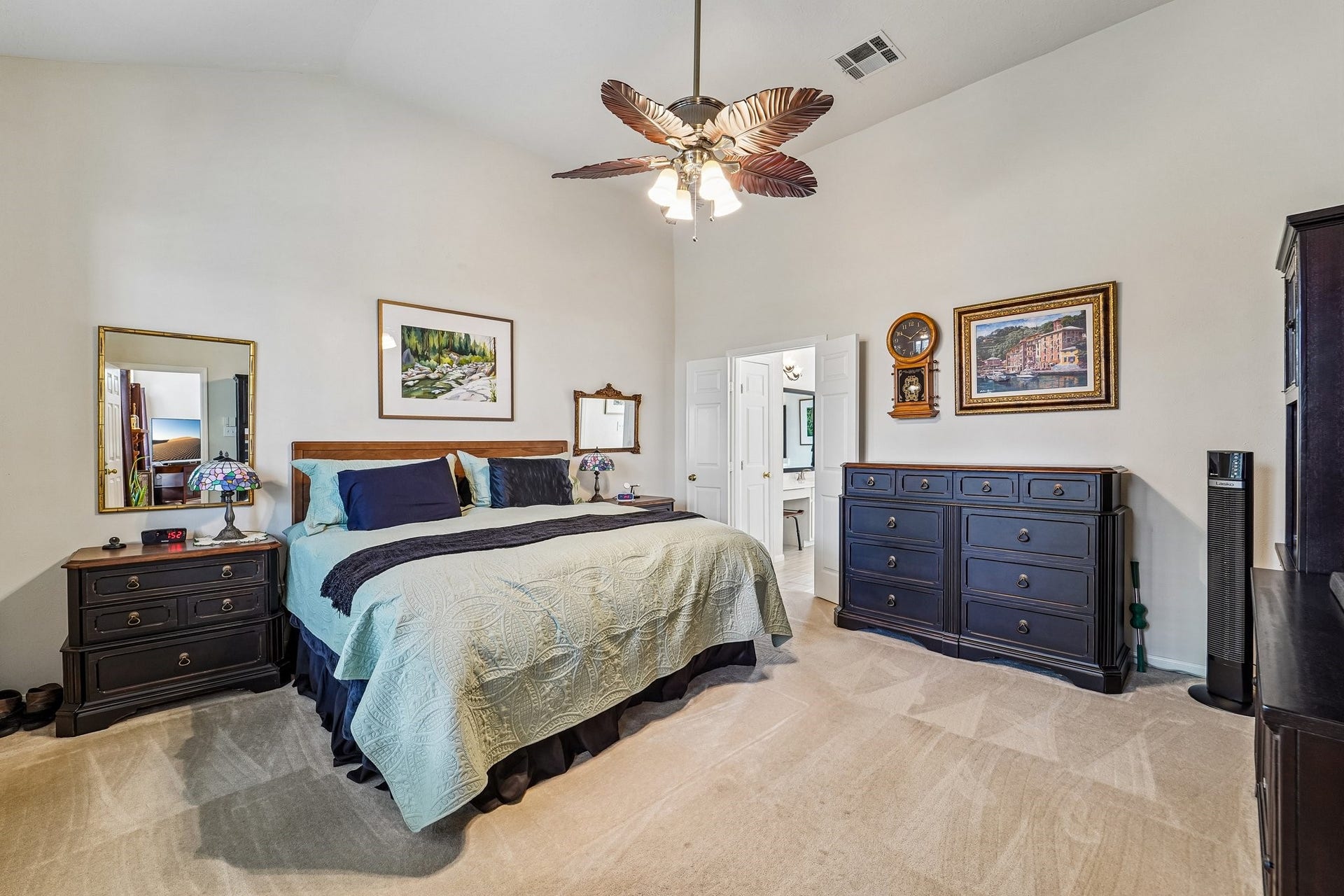 14 Serene Creek Place, The Woodlands, TX 77382 Spacious primary bedroom featuring a vaulted ceiling, elegant ceiling fan, and ample natural light.