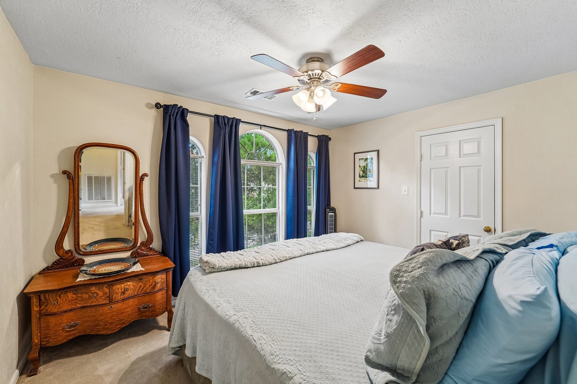14 Serene Creek Place, The Woodlands, TX 77382 Bedroom #3 - this is a large bedroom and currently features a king size bed and dresser.