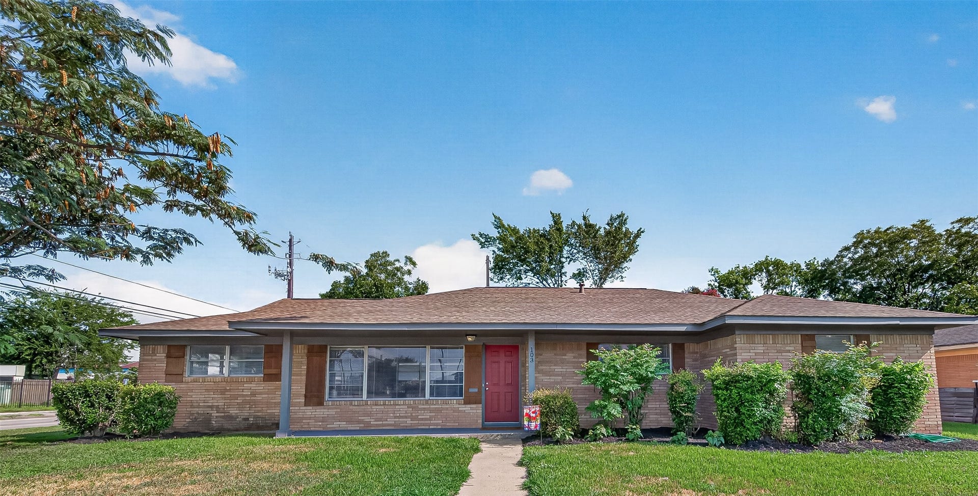 103 E Janisch Road, Houston, TX 77022 Charming single-story brick home with a welcoming red door and lush landscaping, offering great curb appeal and a cozy front porch. This home offers 4 bedrooms + 2.5 baths. Second home has 1 bedroom and 1 bath.
