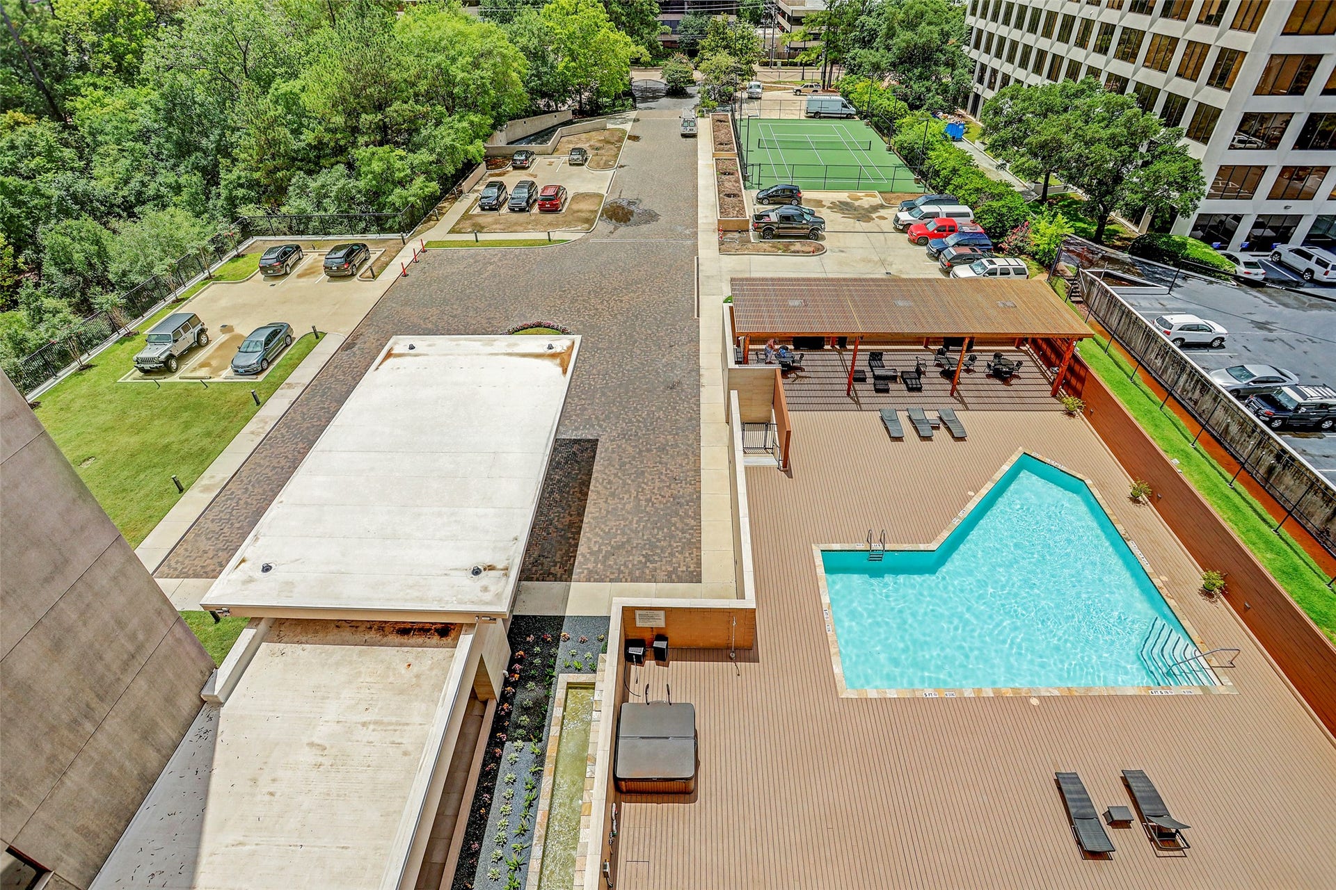49 Briar Hollow Lane, #702, Houston, TX 77027 Aerial view of the pool, entry and tennis court.
