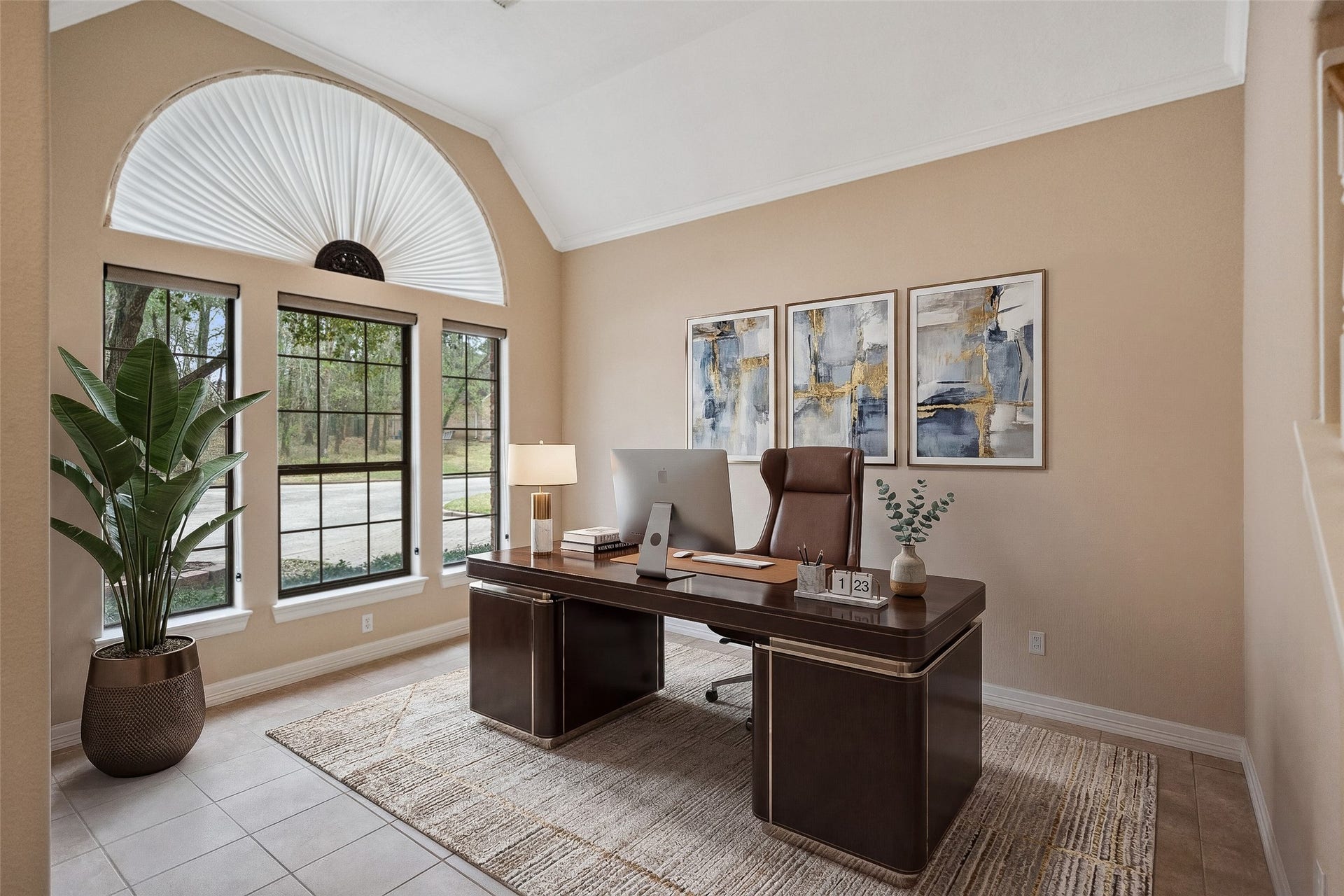 901 Longmire Road, #28, Conroe, TX 77304 A bright, inviting virtually staged home office with large windows offering ample natural light creating a productive and serene workspace.