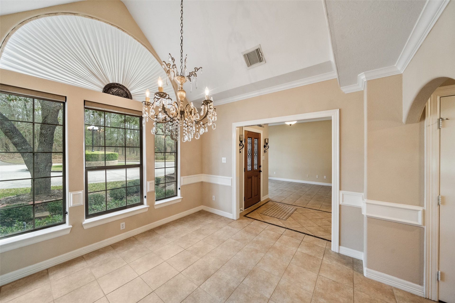 901 Longmire Road, #28, Conroe, TX 77304 Formal dining features large windows for abundant natural light. Layout leads to adjoining kitchen, ideal for dining or entertaining.