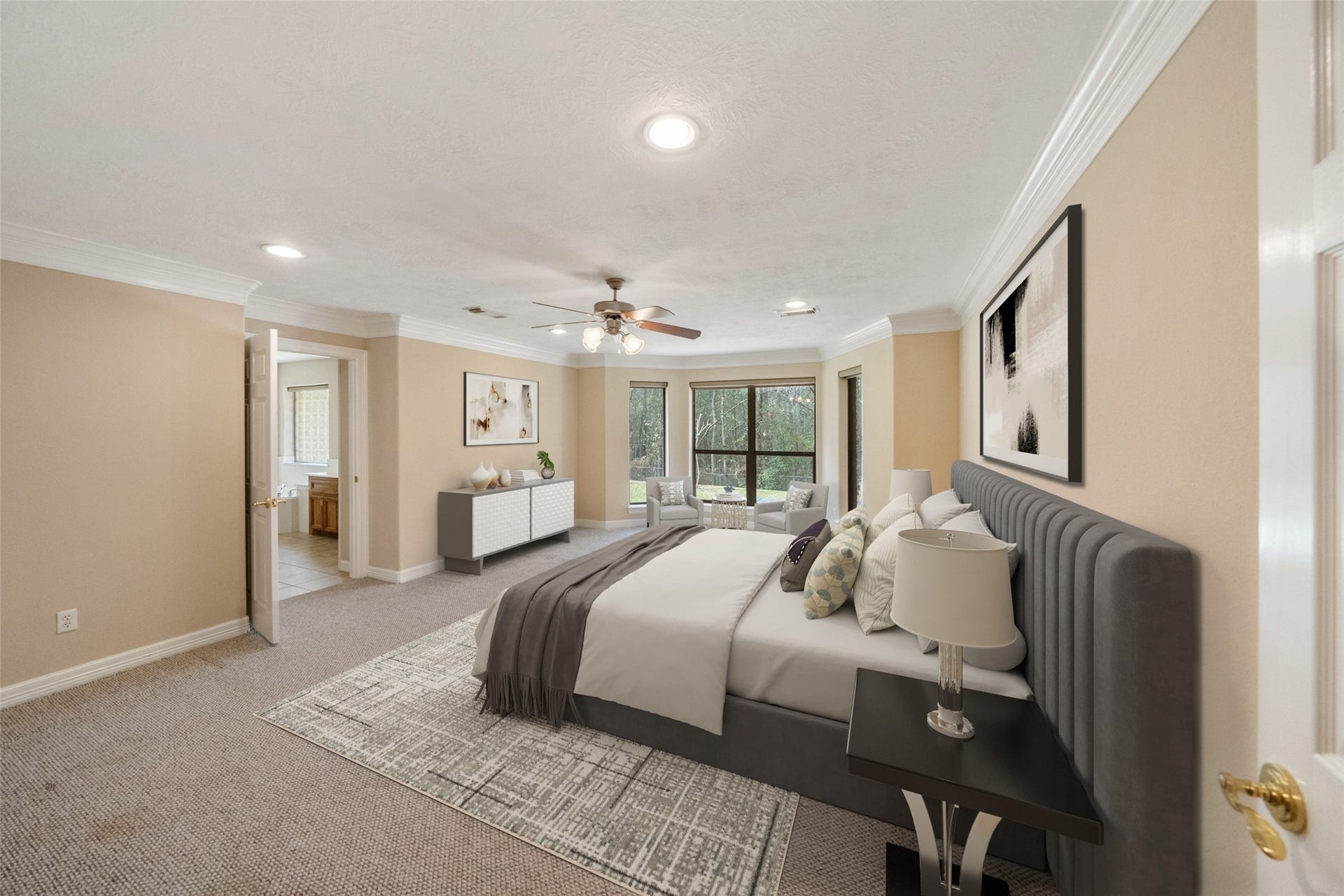 901 Longmire Road, #28, Conroe, TX 77304 This spacious virtually staged first floor primary bedroom with a cozy seating area by the window. An en-suite bathroom for added convenience.