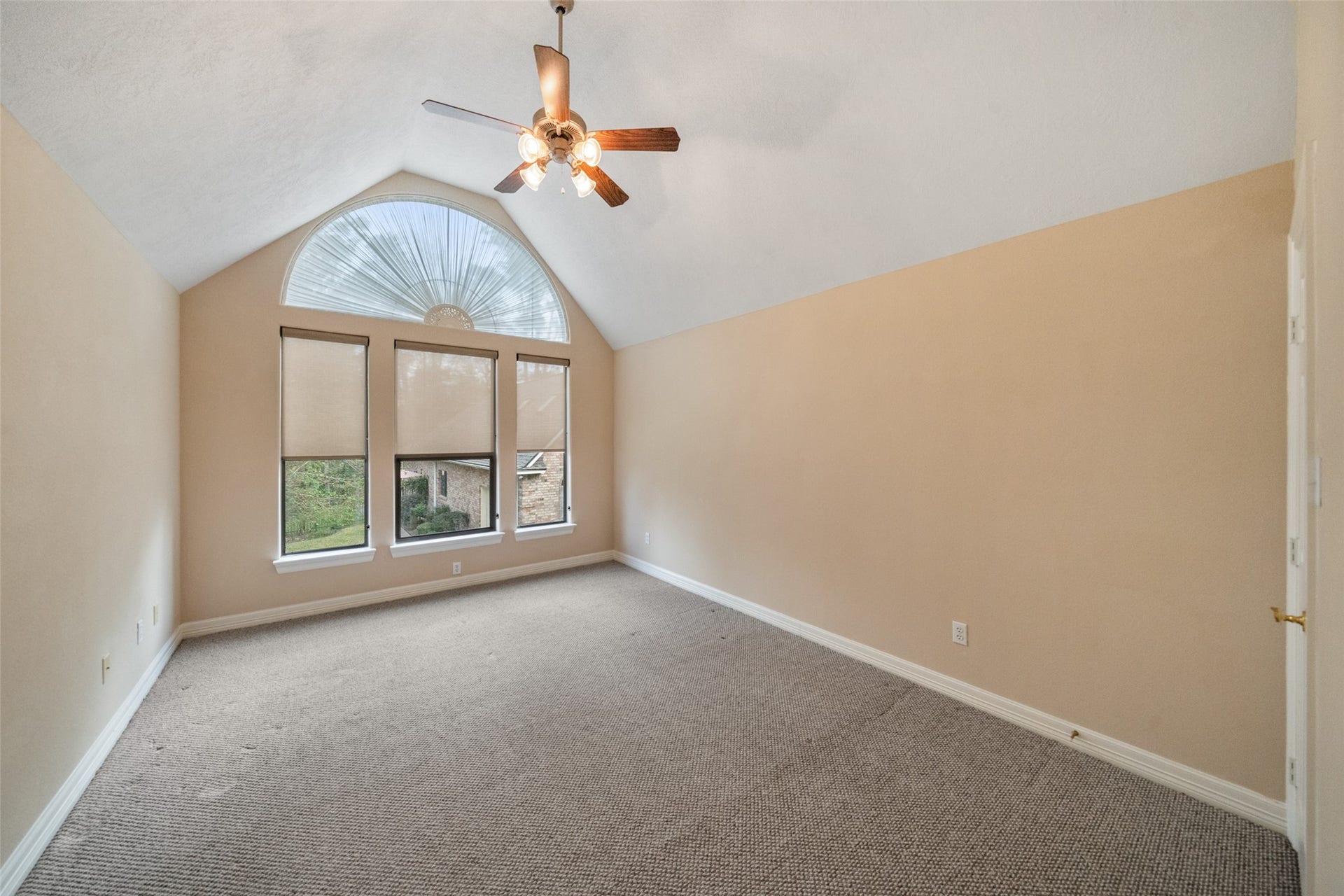 901 Longmire Road, #28, Conroe, TX 77304 Upstairs spacious room features a vaulted ceiling with large windows with unique arch detail, allowing plenty of natural light. This room can be used for a 4th bedroom, a craft room, exercise room, 2nd office, the options or numerous.