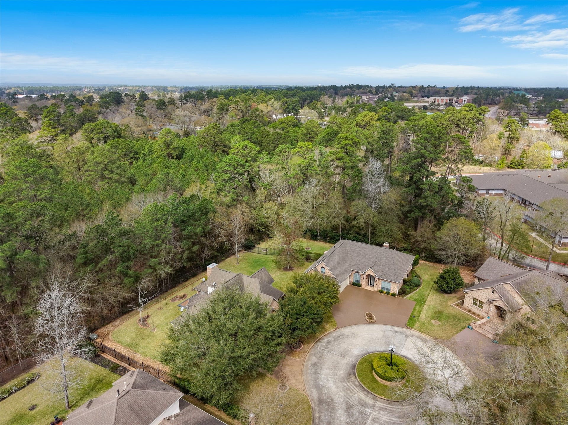 901 Longmire Road, #28, Conroe, TX 77304 Home located in a serene gated neighborhood. The property is situated at the end of a quiet cul-de-sac, offering privacy and a picturesque setting with mature trees and well-maintained landscaping.