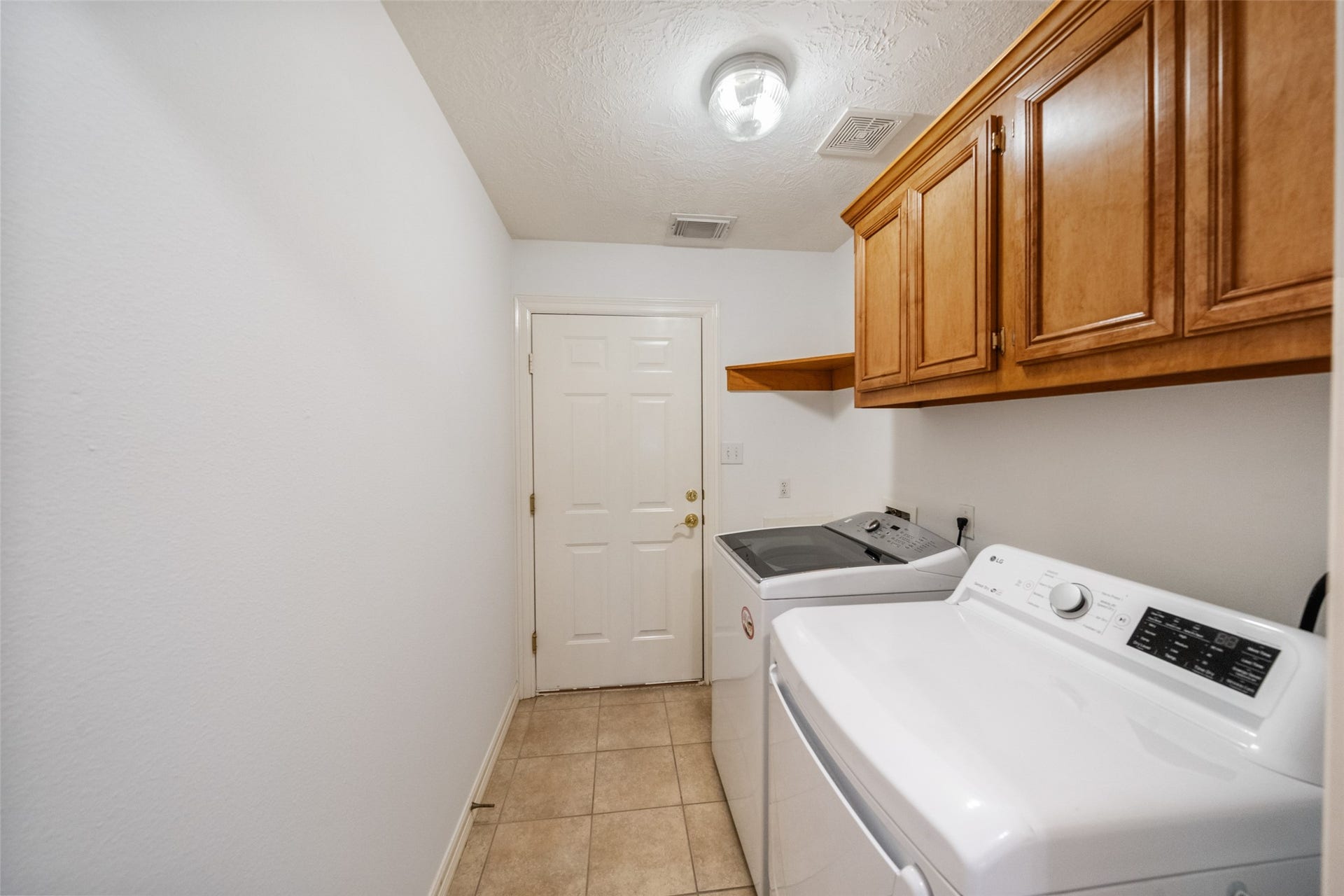 901 Longmire Road, #28, Conroe, TX 77304 Laundry room leading to garage with cabinetry for ample storage. Washer and Dryer are included.