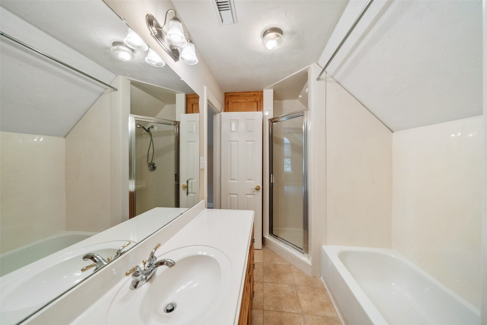 901 Longmire Road, #28, Conroe, TX 77304 Upstairs secondary bathroom features a clean, modern design with a separate shower, a bathtub, and a single-sink vanity.