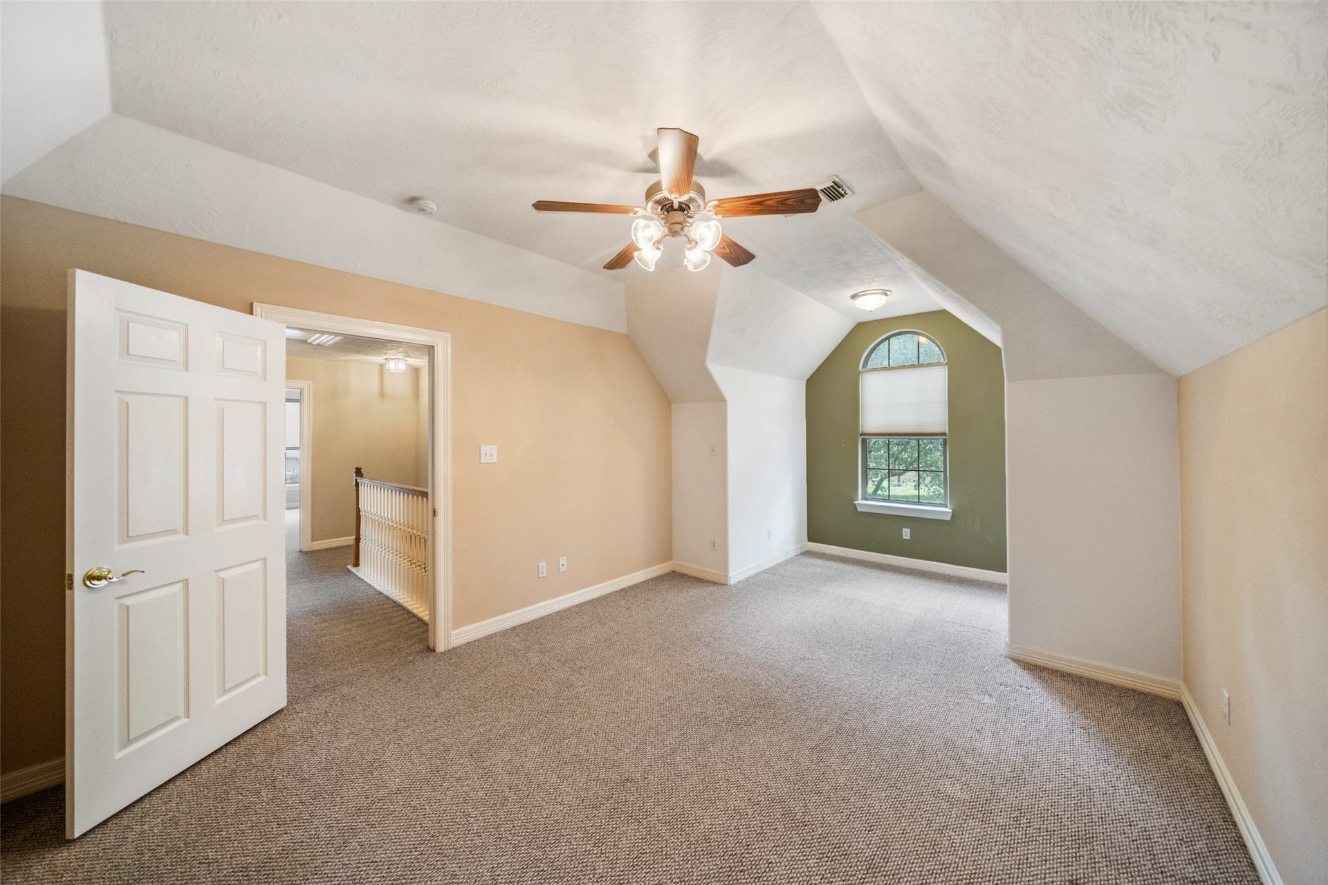 901 Longmire Road, #28, Conroe, TX 77304 Upstairs secondary bedroom is bright, spacious room with sloped ceilings, neutral walls, and carpeted floors. Ensuite bath with a spacious walk in closet.