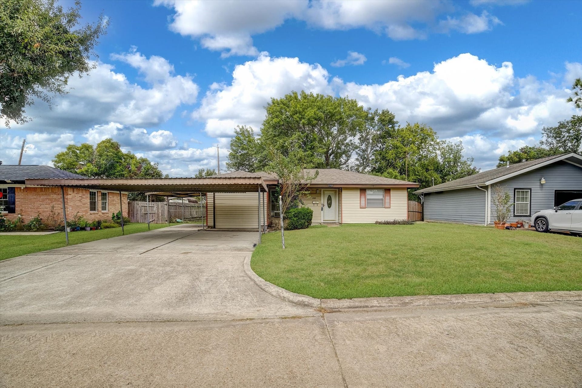 Spacious driveway and a convenient carport, nestled in a quiet neighborhood