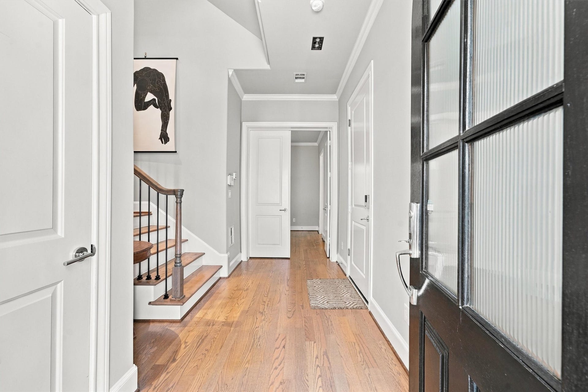 1306 Castle Court, Houston, TX 77006 Entry hall with wood floors, crown molding and solid-core doors